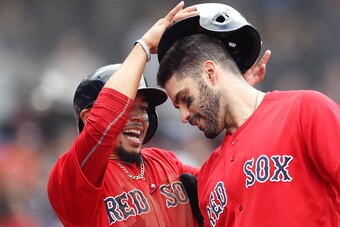 BOSTON, MA - SEPTEMBER 26: Mookie Betts #50 of the Boston Red Sox removes the helmet of J.D. Martinez #28 after Martinez hit a three run home run during the fourth inning against the Baltimore Orioles at Fenway Park on September 26, 2018 in Boston, Massac
