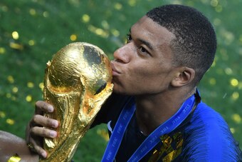 France's forward Kylian Mbappe kisses the trophy at the end of the Russia 2018 World Cup final football match between France and Croatia at the Luzhniki Stadium in Moscow on July 15, 2018. (Photo by Kirill KUDRYAVTSEV / AFP) / RESTRICTED TO EDITORIAL USE 