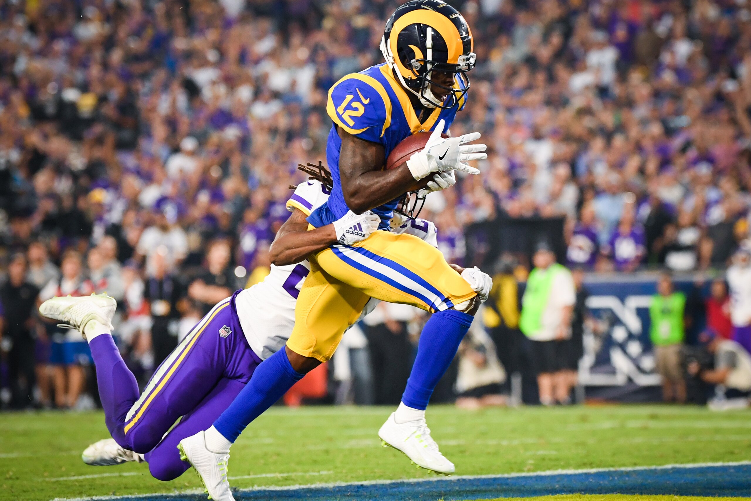 LOS ANGELES, CA - SEPTEMBER 27: Wide receiver Brandin Cooks #12 of the Los Angeles Rams makes a catch for a touchdown in front of cornerback Trae Waynes #26 of the Minnesota Vikings to take a 28-17 lead in the second quarter at Los Angeles Memorial Colise