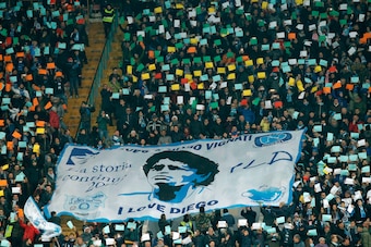 Napoli's fans deploy a giant banner showing Argentinian football star Diego Maradona before the Italian Serie A football match Napoli vs Juventus on December 1, 2017 at the San Paolo stadium in Naples. (Photo by CARLO HERMANN / AFP)        (Photo credit s
