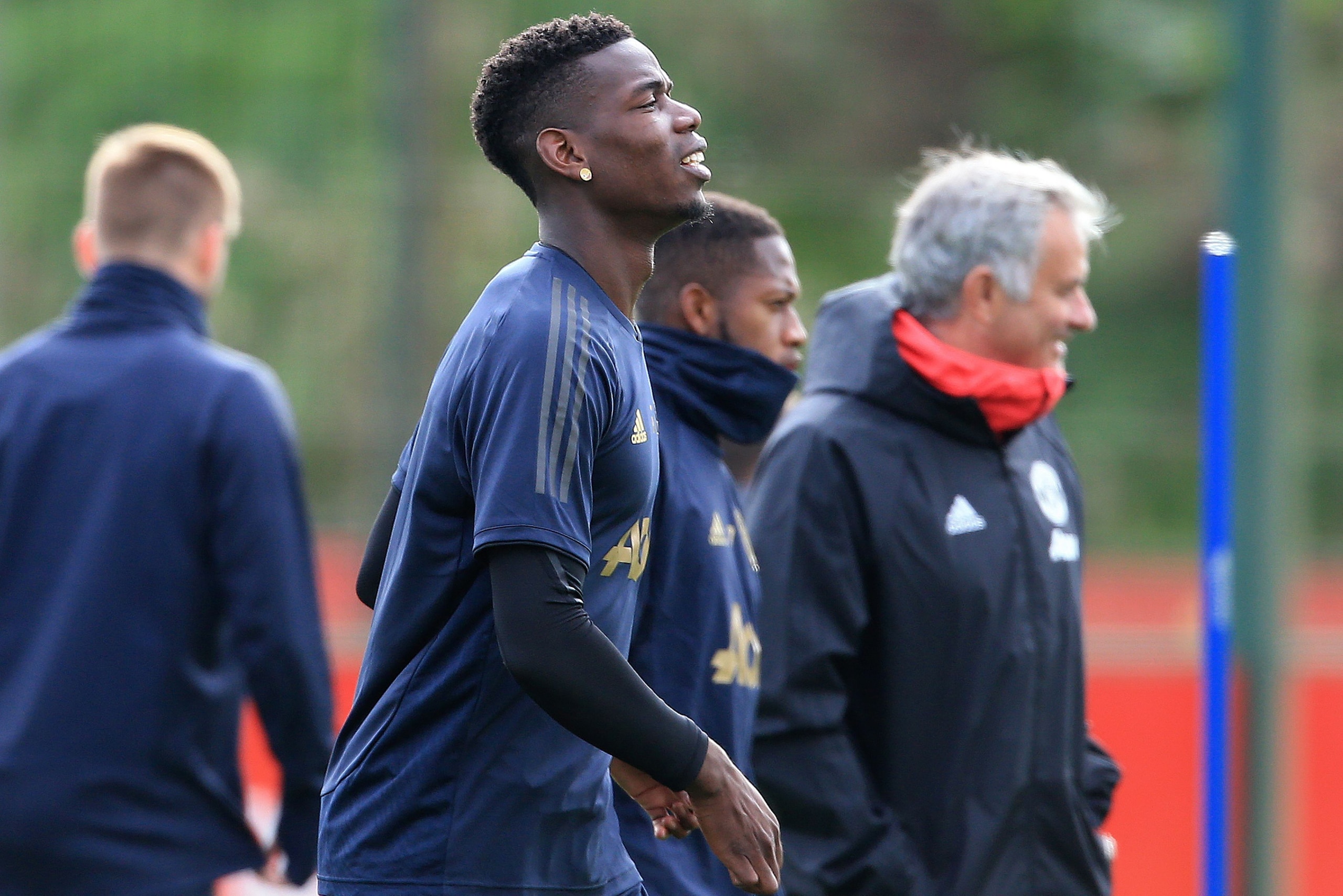 Manchester United's French midfielder Paul Pogba (L) and Manchester United's Portuguese manager Jose Mourinho (R) attend a training session at the Carrington Training complex in Manchester, north west England on October 1, 2018, ahead of their Champions L