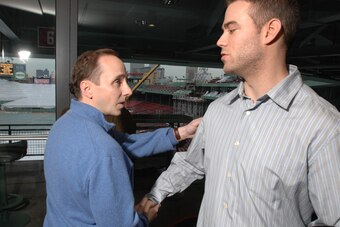 Brian Cashman and Theo Epstein greet each other a few years after the 2003 ALCS left the Yankees GM at a loss as to how to congratulate Epstein on Boston's season.