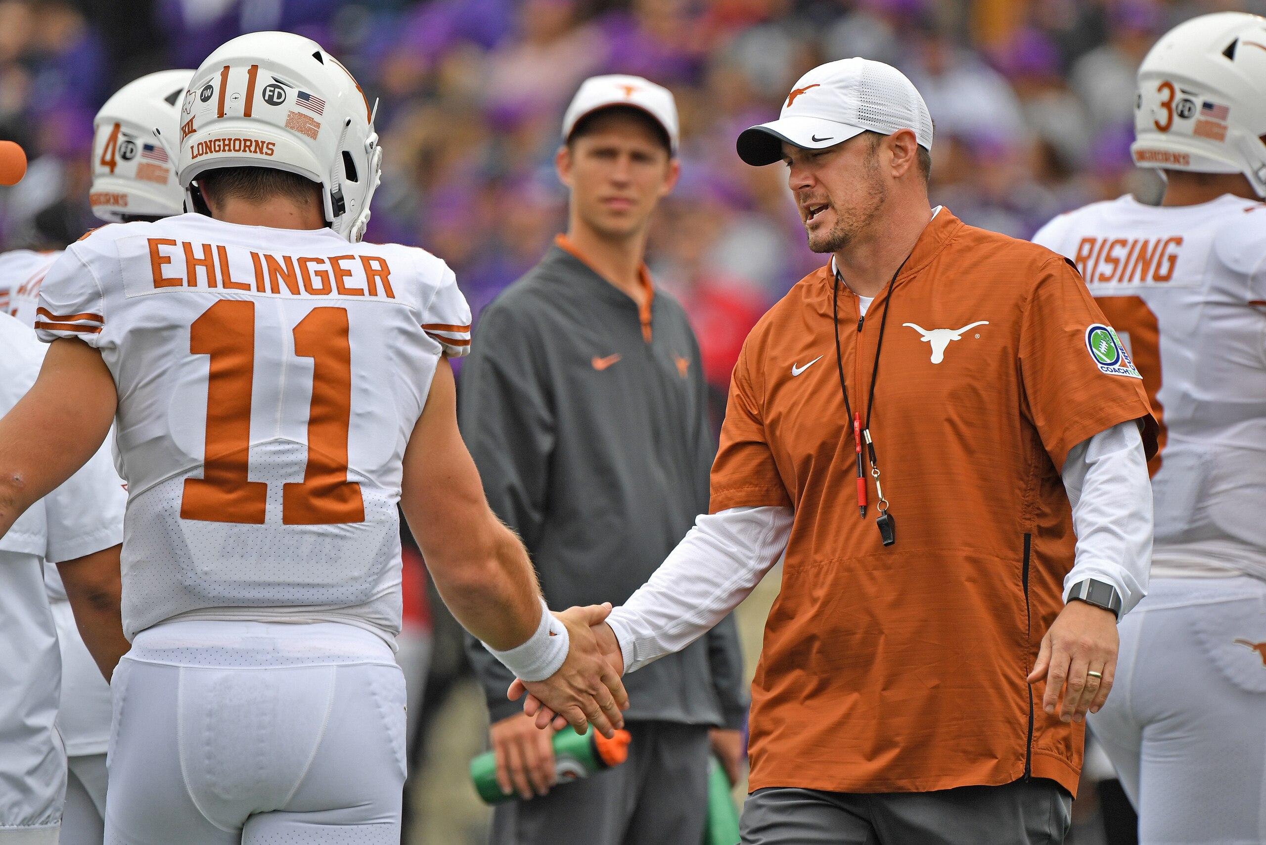 MANHATTAN, KS - SEPTEMBER 29:  Head coach Tom Herman  (R) of the Texas Longhorns shakes hands with quarterback Sam Ehlinger #11 during pre-game activities, prior to a game against the Kansas State Wildcats on September 29, 2018 at Bill Snyder Family Stadi