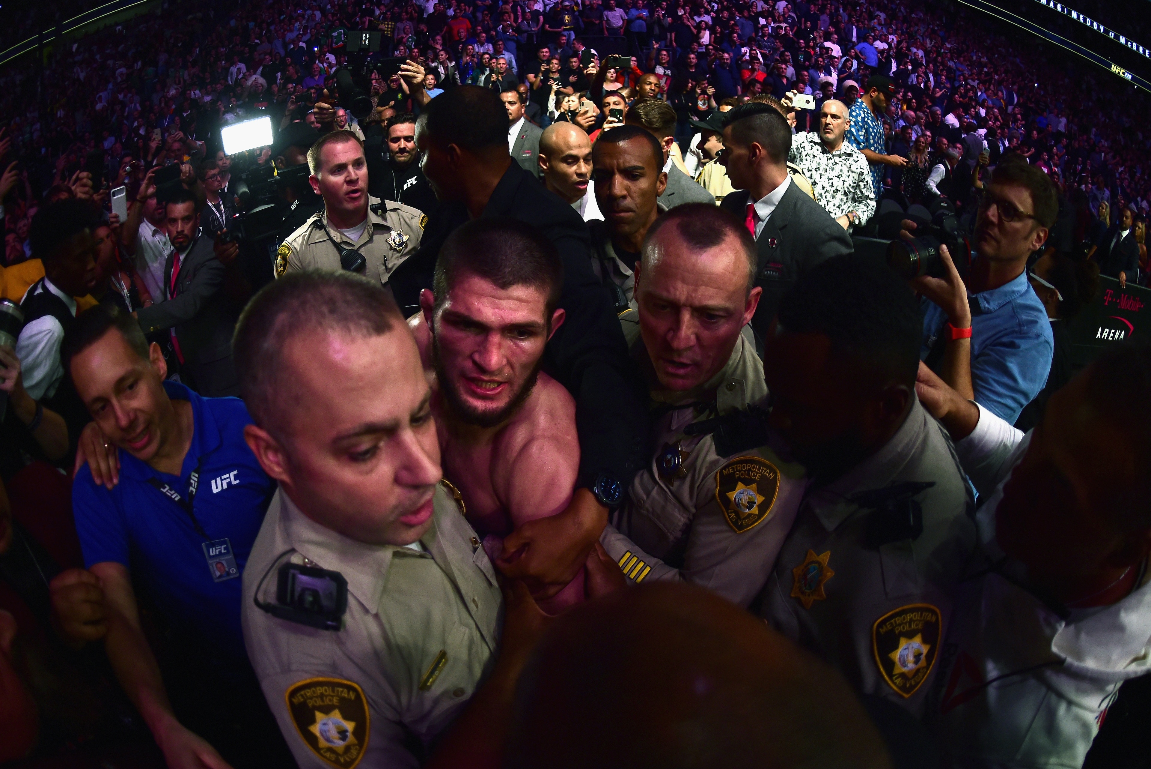 LAS VEGAS, NV - OCTOBER 06:  Khabib Nurmagomedov of Russia is escorted out of the arena after defeating Conor McGregor of Ireland in their UFC lightweight championship bout during the UFC 229 event inside T-Mobile Arena on October 6, 2018 in Las Vegas, Ne