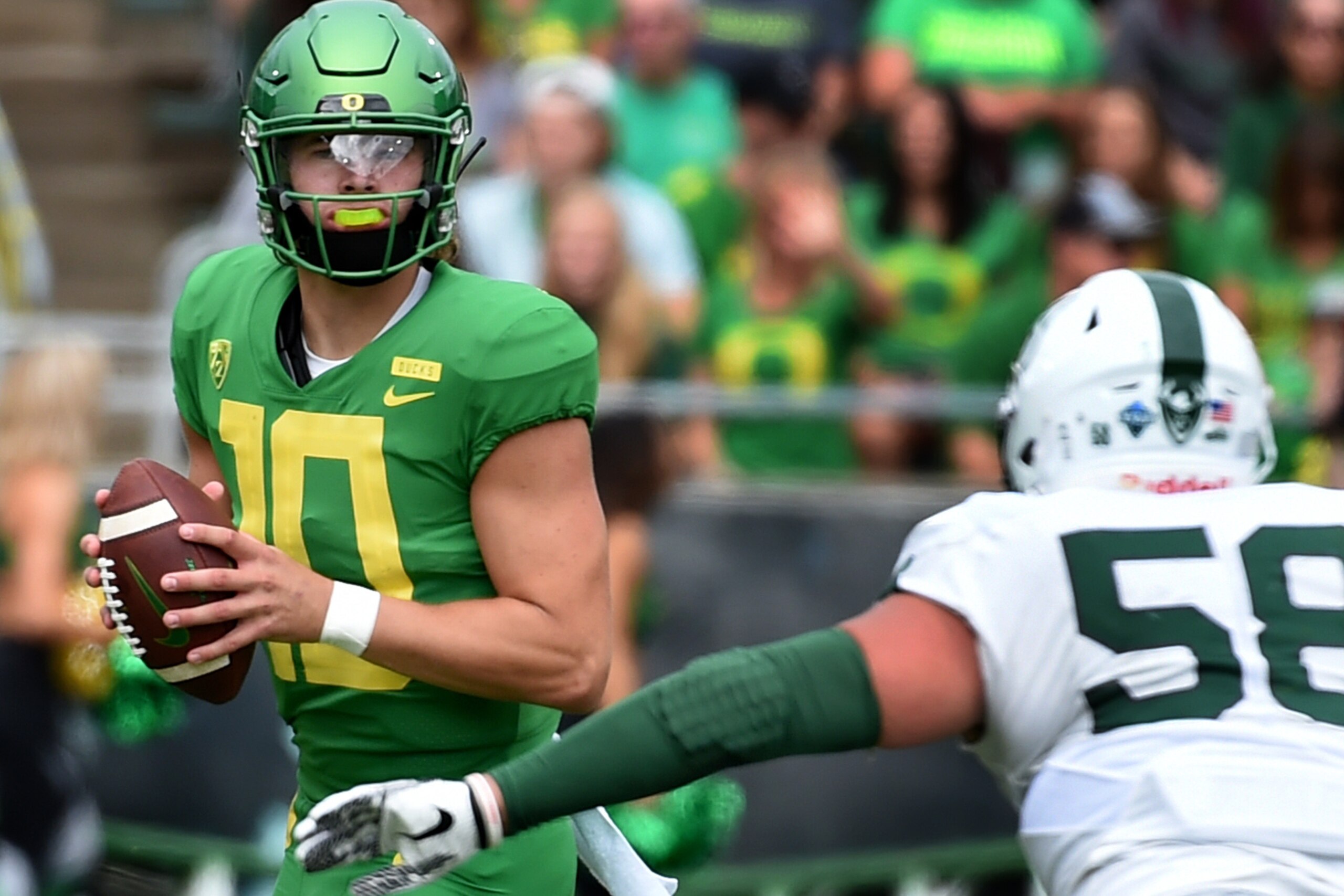 EUGENE, OR - SEPTEMBER 08: Justin Herbert #10 of the Oregon Ducks drops back to pass as defensive tackle Dallas House #58 of the Portland State Vikings apples pressure during the first half of the game against at Autzen Stadium on September 8, 2018 in Eug