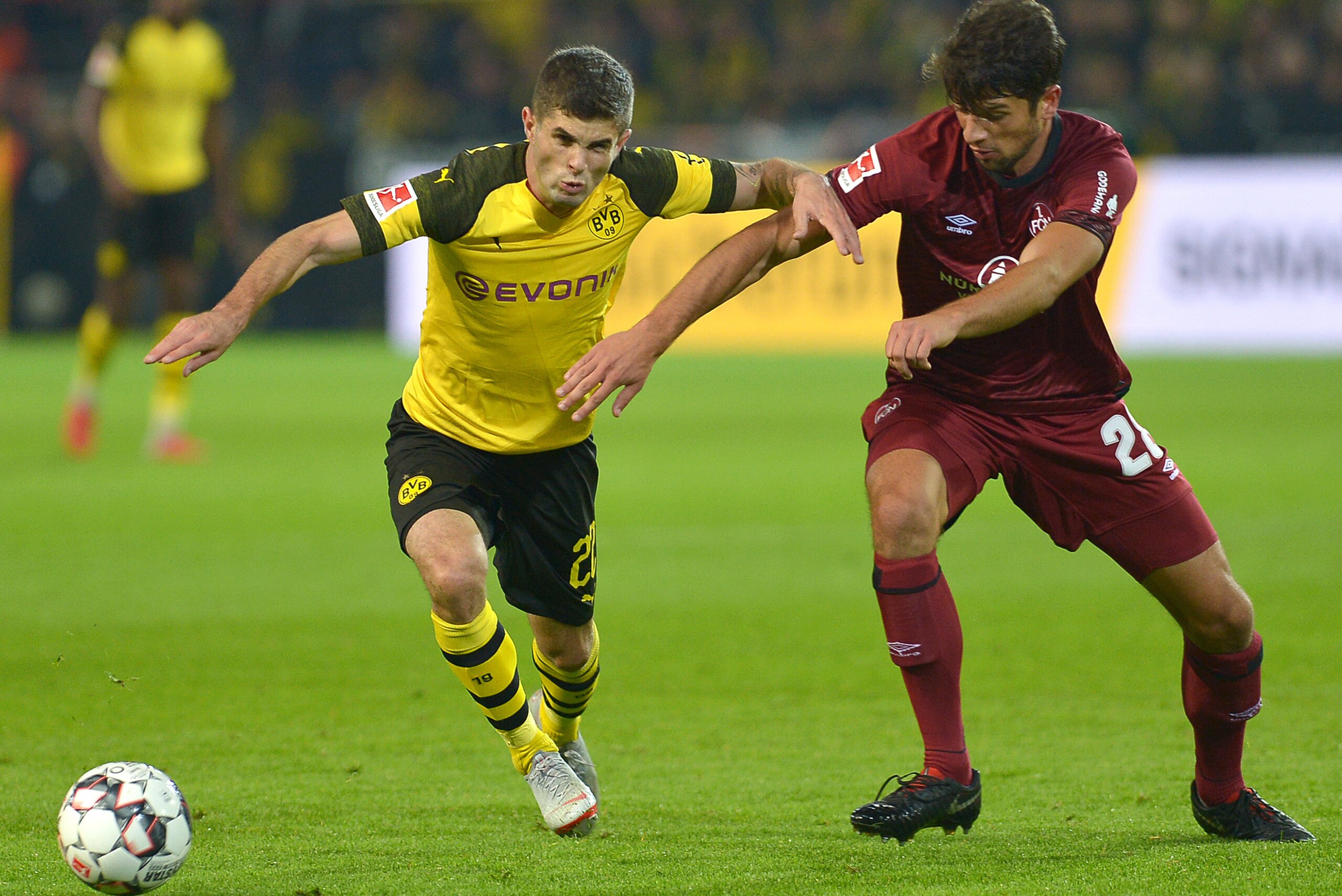 DORTMUND, GERMANY - SEPTEMBER 26: Christian Pulisic of Borussia Dortmund and Lukas Muehl of FC Nuernberg battle for the ball during the Bundesliga match between Borussia Dortmund and 1. FC Nuernberg at Signal Iduna Park on September 26, 2018 in Dortmund, 