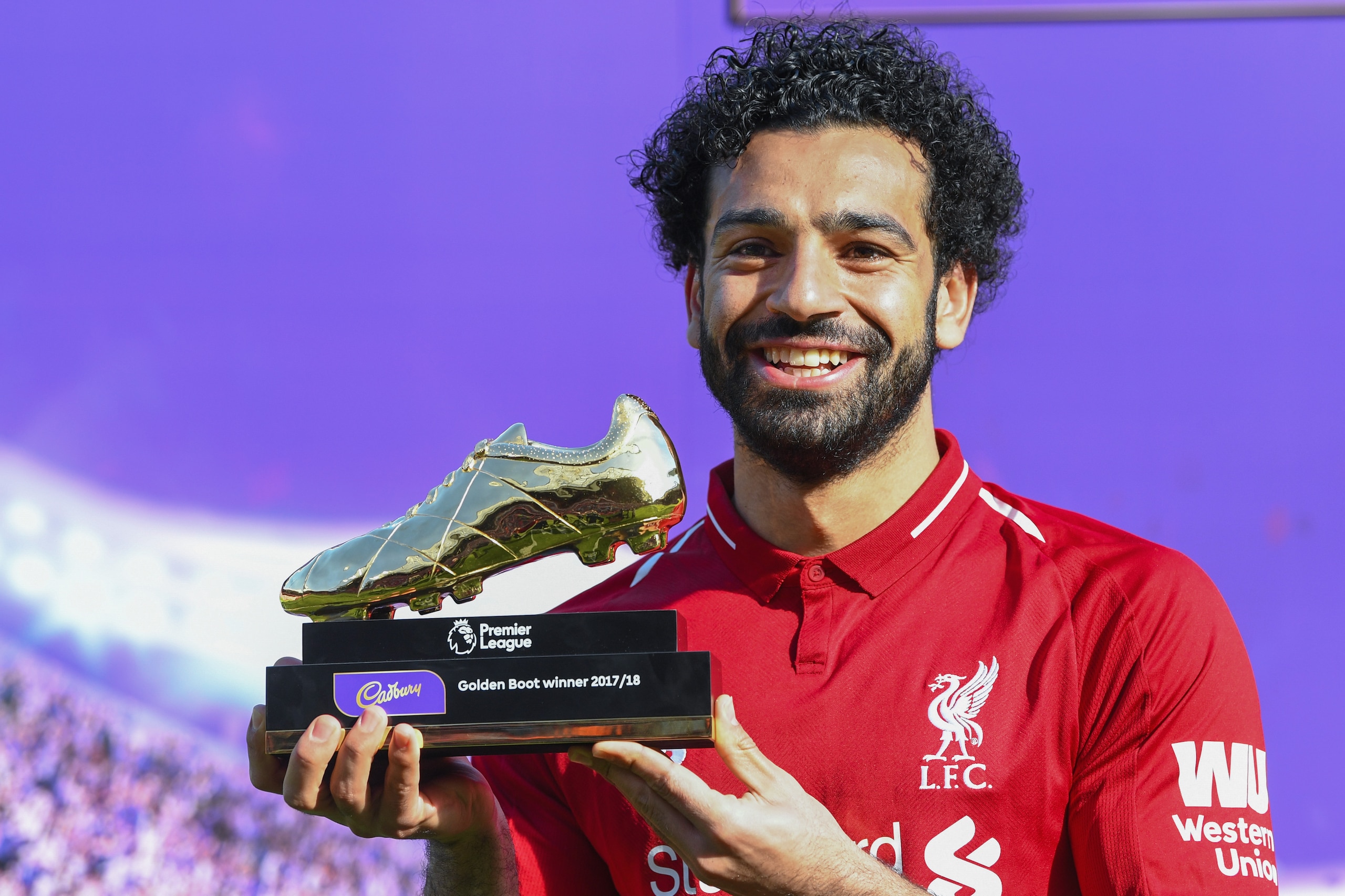LIVERPOOL, ENGLAND - MAY 13: Mohamed Salah of Liverpool poses for a photo with his Premier League Golden Boot Award after the Premier League match between Liverpool and Brighton and Hove Albion at Anfield on May 13, 2018 in Liverpool, England. (Photo by M