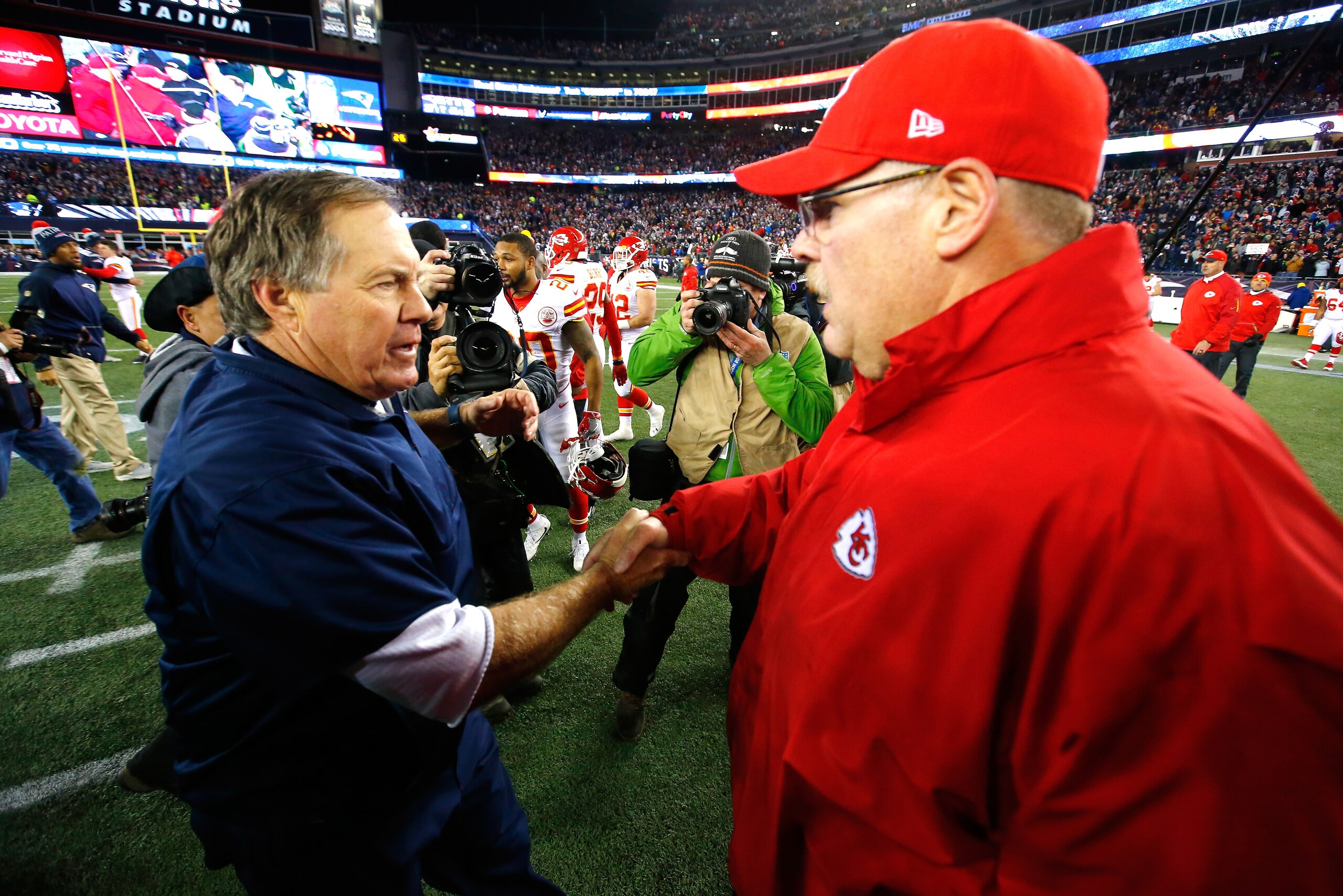 FOXBORO, MA - JANUARY 16:  Head coach Bill Belichick of the New England Patriots and head coach Andy Reid of the Kansas City Chiefs shake hands after the AFC Divisional Playoff Game at Gillette Stadium on January 16, 2016 in Foxboro, Massachusetts. The Pa