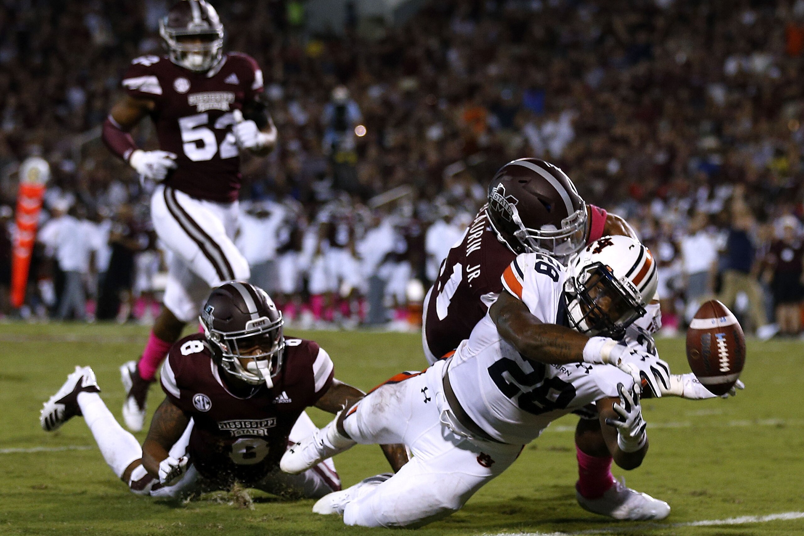 STARKVILLE, MS - OCTOBER 06:  JaTarvious Whitlow #28 of the Auburn Tigers fumbles the ball as Mark McLaurin #41 and Maurice Smitherman #8 of the Mississippi State Bulldogs defend during the second half at Davis Wade Stadium on October 6, 2018 in Starkvill