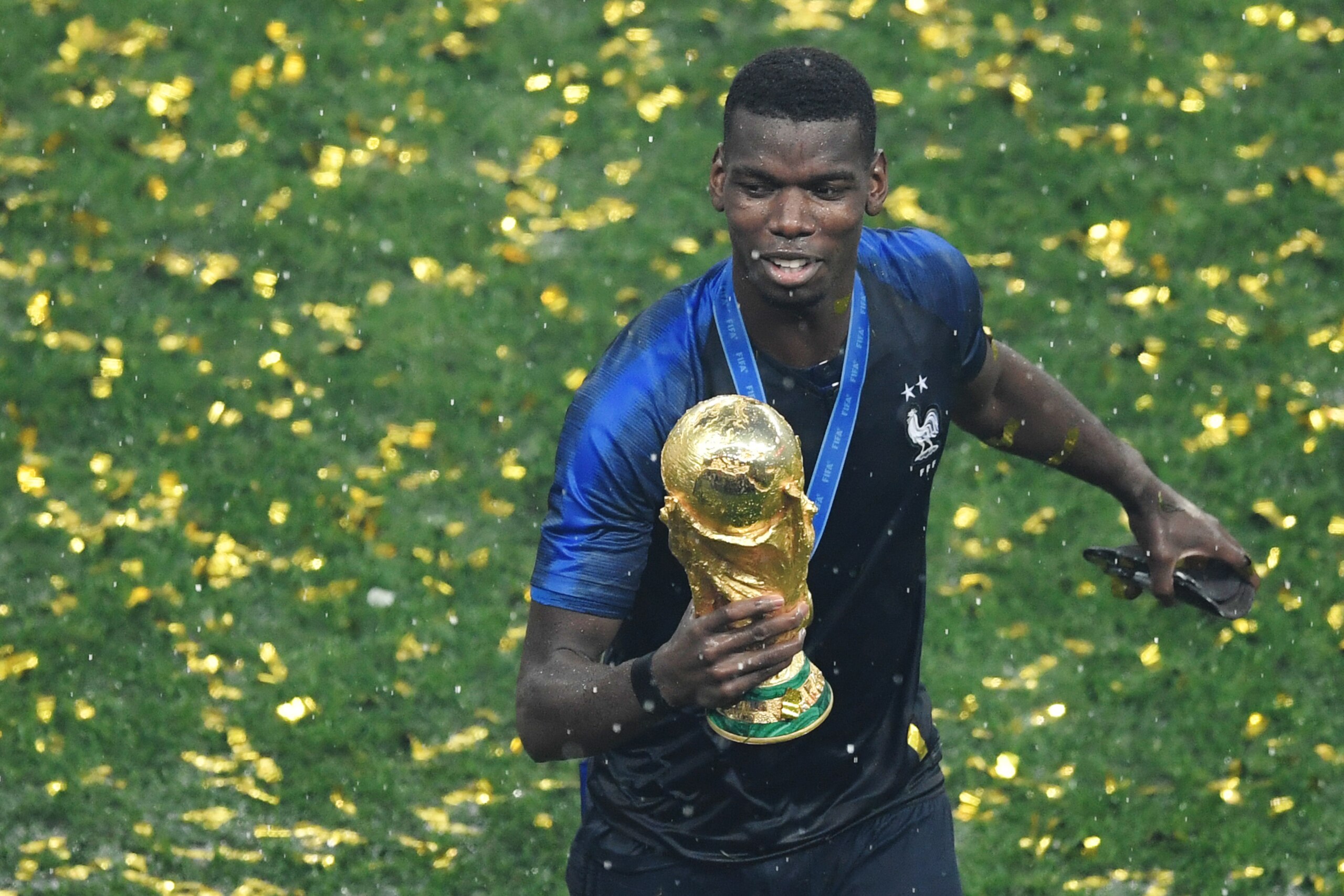 France's midfielder Paul Pogba holds the trophy as he celebrates during the trophy ceremony after winning the Russia 2018 World Cup final football match between France and Croatia at the Luzhniki Stadium in Moscow on July 15, 2018. (Photo by GABRIEL BOUYS