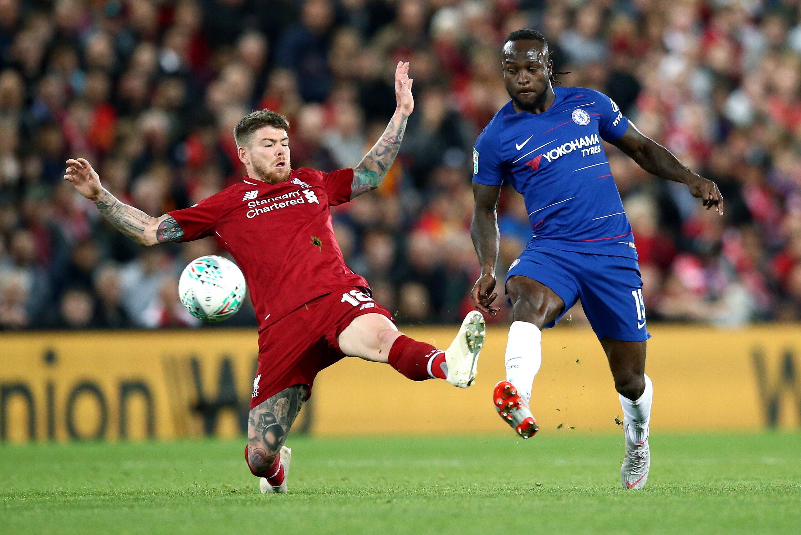 LIVERPOOL, ENGLAND - SEPTEMBER 26: Victor Moses of Chelsea is challenged by Alberto Moreno of Liverpool during the Carabao Cup Third Round match between Liverpool and Chelsea at Anfield on September 26, 2018 in Liverpool, England.  (Photo by Jan Kruger/Ge