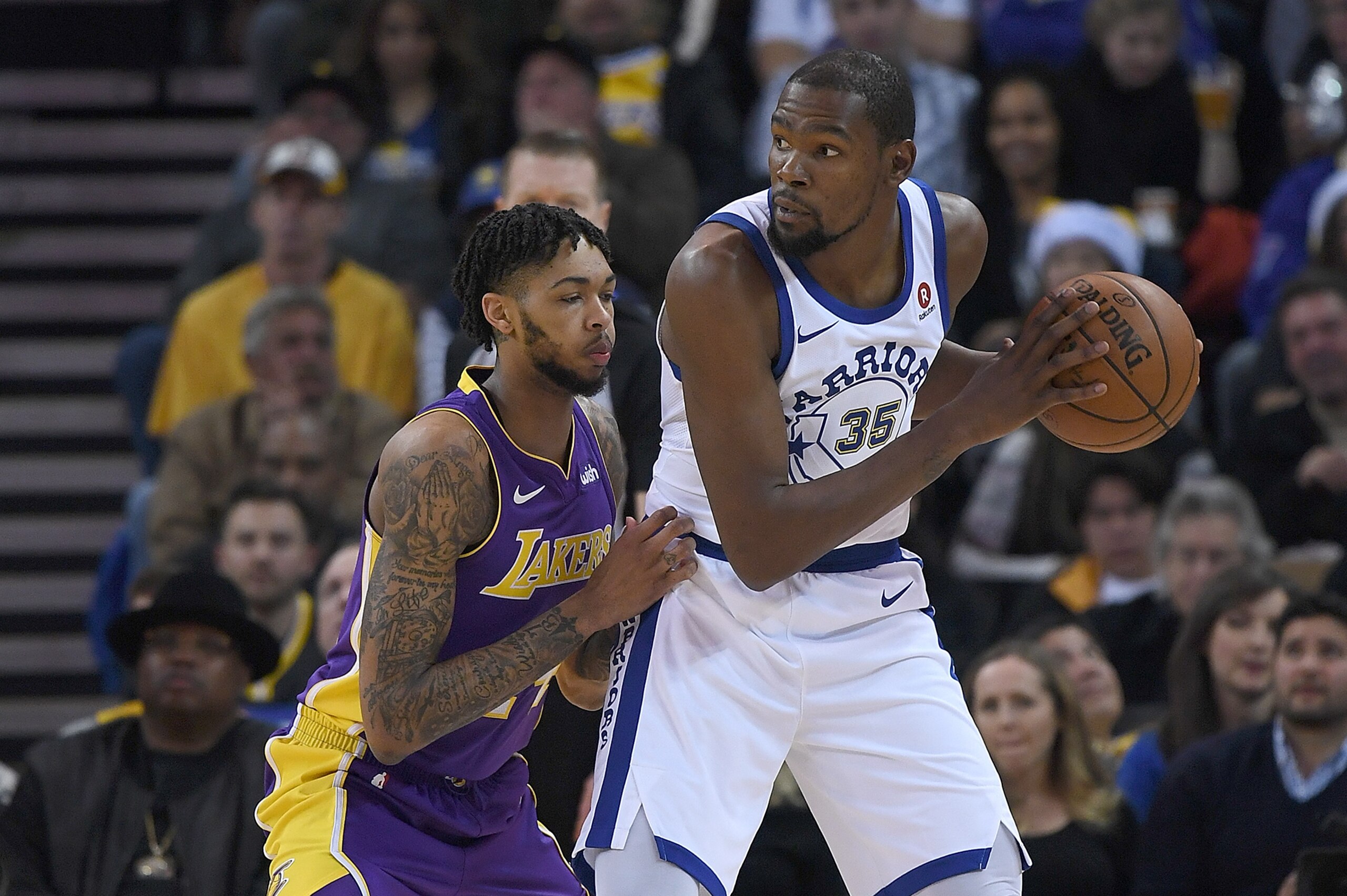 OAKLAND, CA - DECEMBER 22:  Kevin Durant #35 of the Golden State Warriors looks to put a move on Brandon Ingram #14 of the Los Angeles Lakers during an NBA basketball game at ORACLE Arena on December 22, 2017 in Oakland, California. NOTE TO USER: User exp