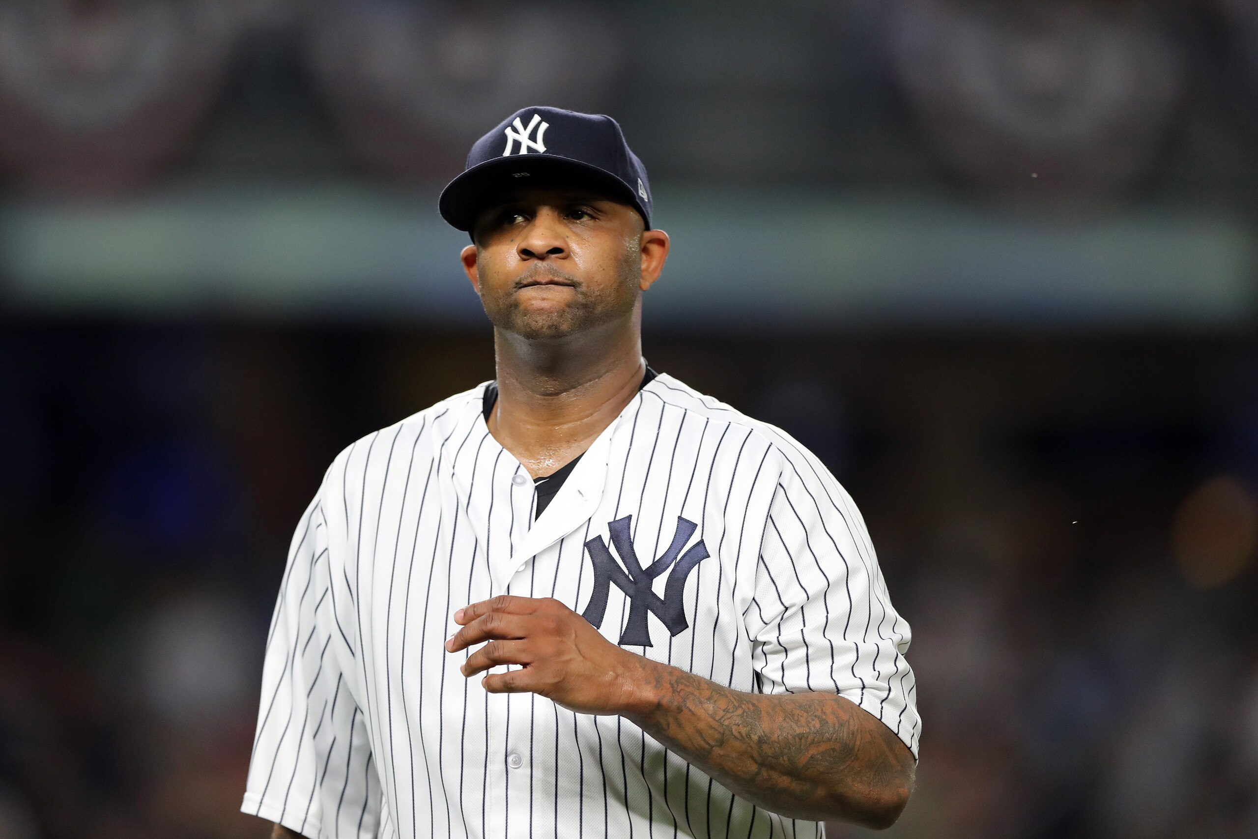 NEW YORK, NEW YORK - OCTOBER 09:  CC Sabathia #52 of the New York Yankees walks back to the dugout after giving up three runs in the third inning against the Boston Red Sox during Game Four American League Division Series at Yankee Stadium on October 09, 