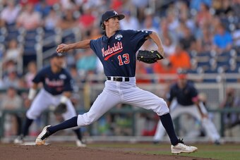 OMAHA, NE - JUNE 23:  Pitcher Walker Buehler #13 of the Vanderbilt Commodores delivers a pitch against the Virginia Cavaliers in the first inning during game one of the College World Series Championship on June 23, 2014 at TD Ameritrade Park in Omaha, Neb