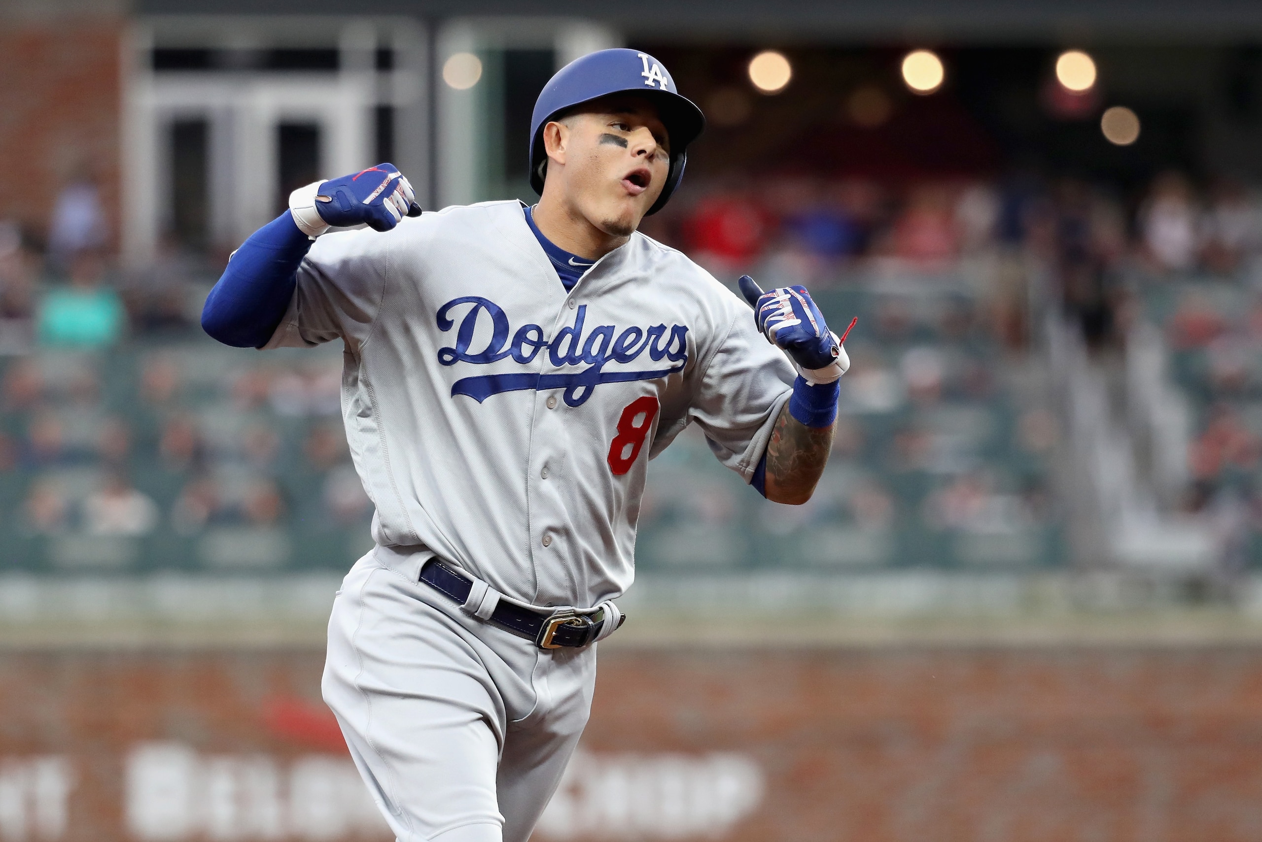 ATLANTA, GA - OCTOBER 08:  Manny Machado #8 of the Los Angeles Dodgers celebrates as he rounds the bases after hitting a three run homerun during the seventh inning of Game Four of the National League Division Series against the Atlanta Braves at Turner F