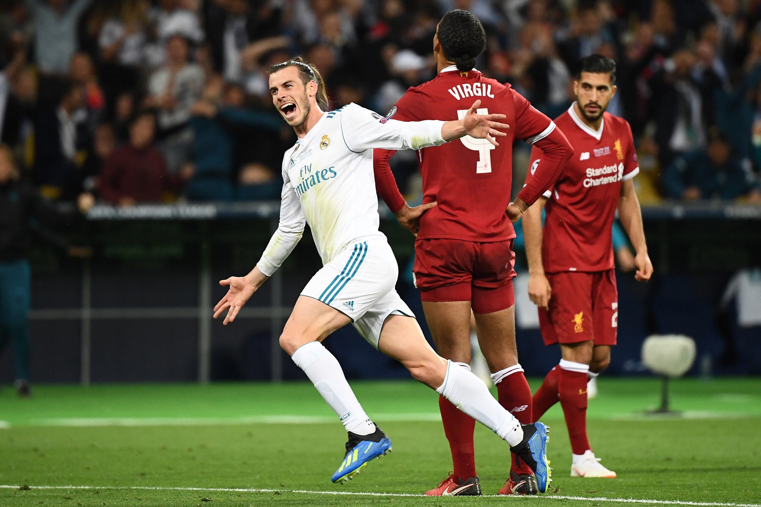 Real Madrid's Welsh forward Gareth Bale (L) reacts after scoring his team's third goal during the UEFA Champions League final football match between Liverpool and Real Madrid at the Olympic Stadium in Kiev, Ukraine, on May 26, 2018. (Photo by FRANCK FIFE 