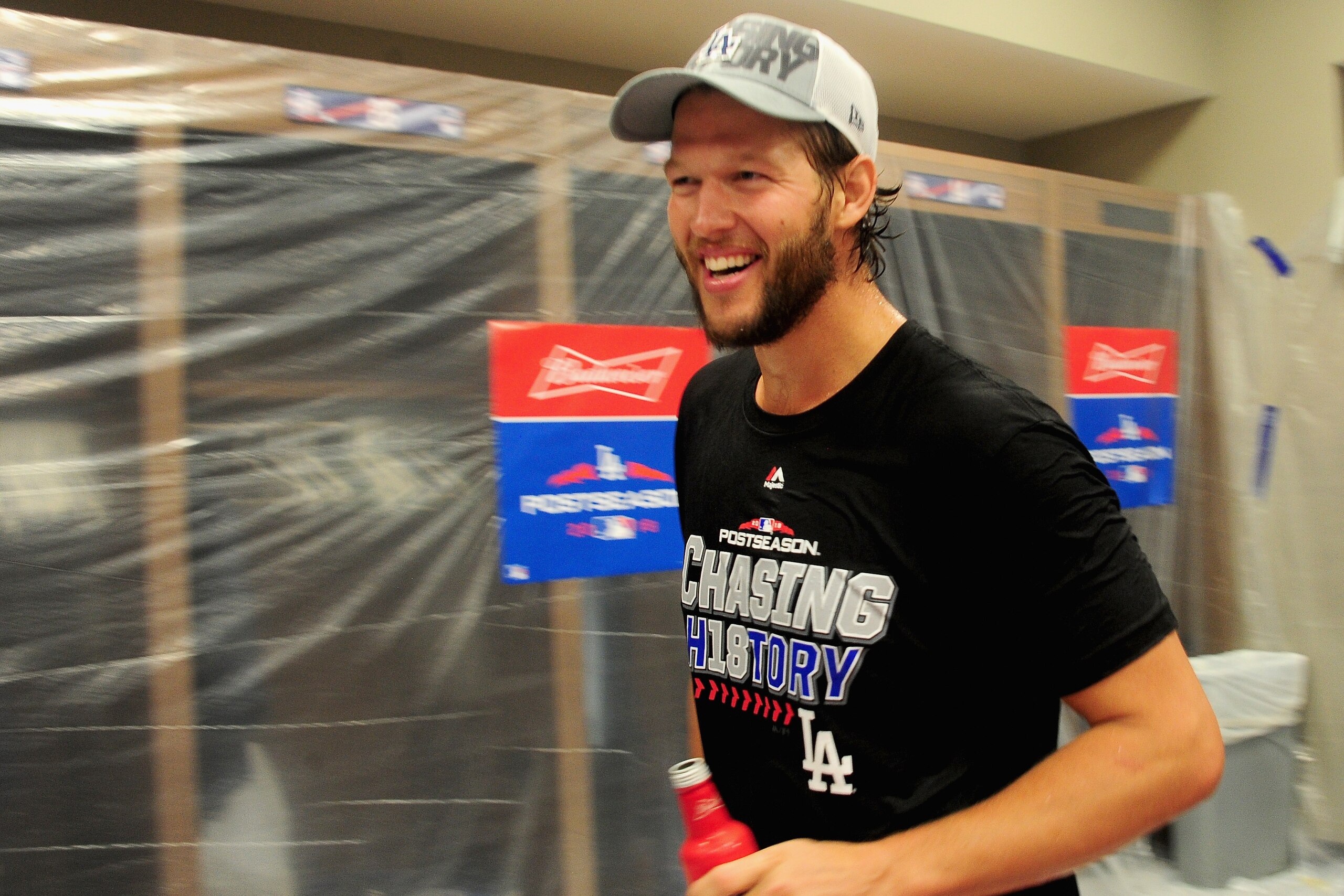ATLANTA, GA - OCTOBER 08:  Clayton Kershaw #22  of the Los Angeles Dodgers celebrates in the locker room after winning Game Four to clinch the National League Division Series with a score of 6-2 over the Atlanta Braves at Turner Field on October 8, 2018 i