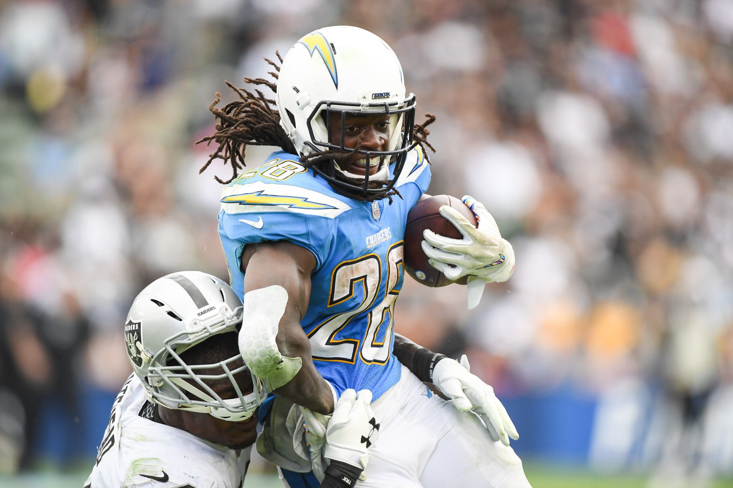 CARSON, CA - OCTOBER 07: Running back Melvin Gordon #28 of the Los Angeles Chargers is tackled by linebacker Tahir Whitehead #59 of the Oakland Raiders in the third quarter at StubHub Center on October 7, 2018 in Carson, California. (Photo by Harry How/Ge