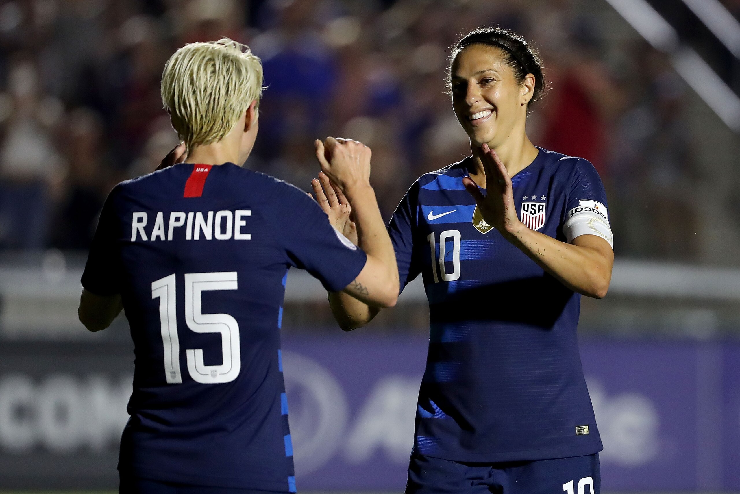 CARY, NC - OCTOBER 04:  Megan Rapinoe #15 reacts after scoring a goal with teammate Carli Lloyd #10 of USA against Mexico during the Group A - CONCACAF Women's Championship at WakeMed Soccer Park on October 4, 2018 in Cary, North Carolina.  (Photo by Stre