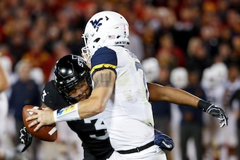 AMES, IA - OCTOBER 13: Defensive end JaQuan Bailey #3 of the Iowa State Cyclones sacks quarterback Will Grier #7 of the West Virginia Mountaineers as he scrambled for yards in the first half of play at Jack Trice Stadium on October 13, 2018 in Ames, Iowa.