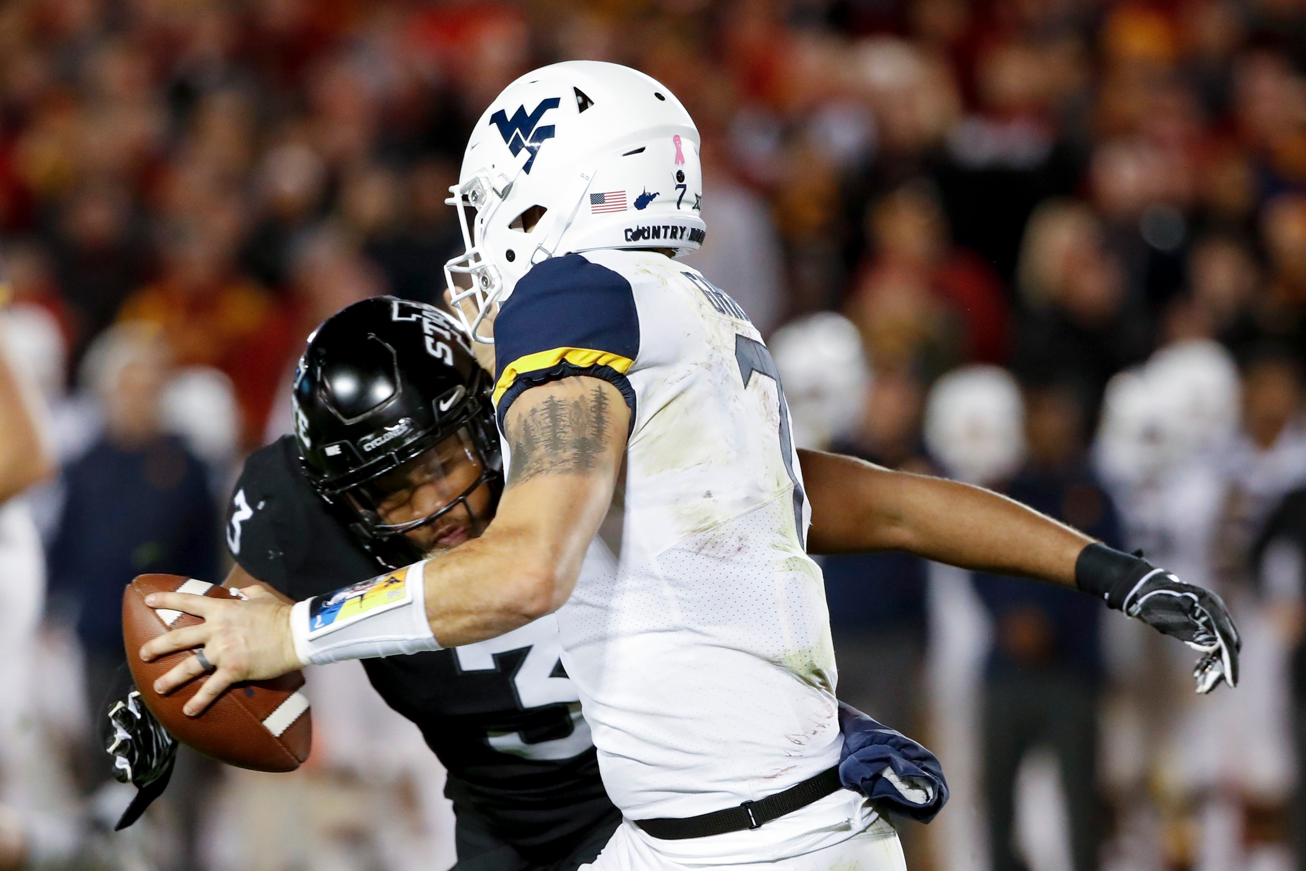 AMES, IA - OCTOBER 13: Defensive end JaQuan Bailey #3 of the Iowa State Cyclones sacks quarterback Will Grier #7 of the West Virginia Mountaineers as he scrambled for yards in the first half of play at Jack Trice Stadium on October 13, 2018 in Ames, Iowa.