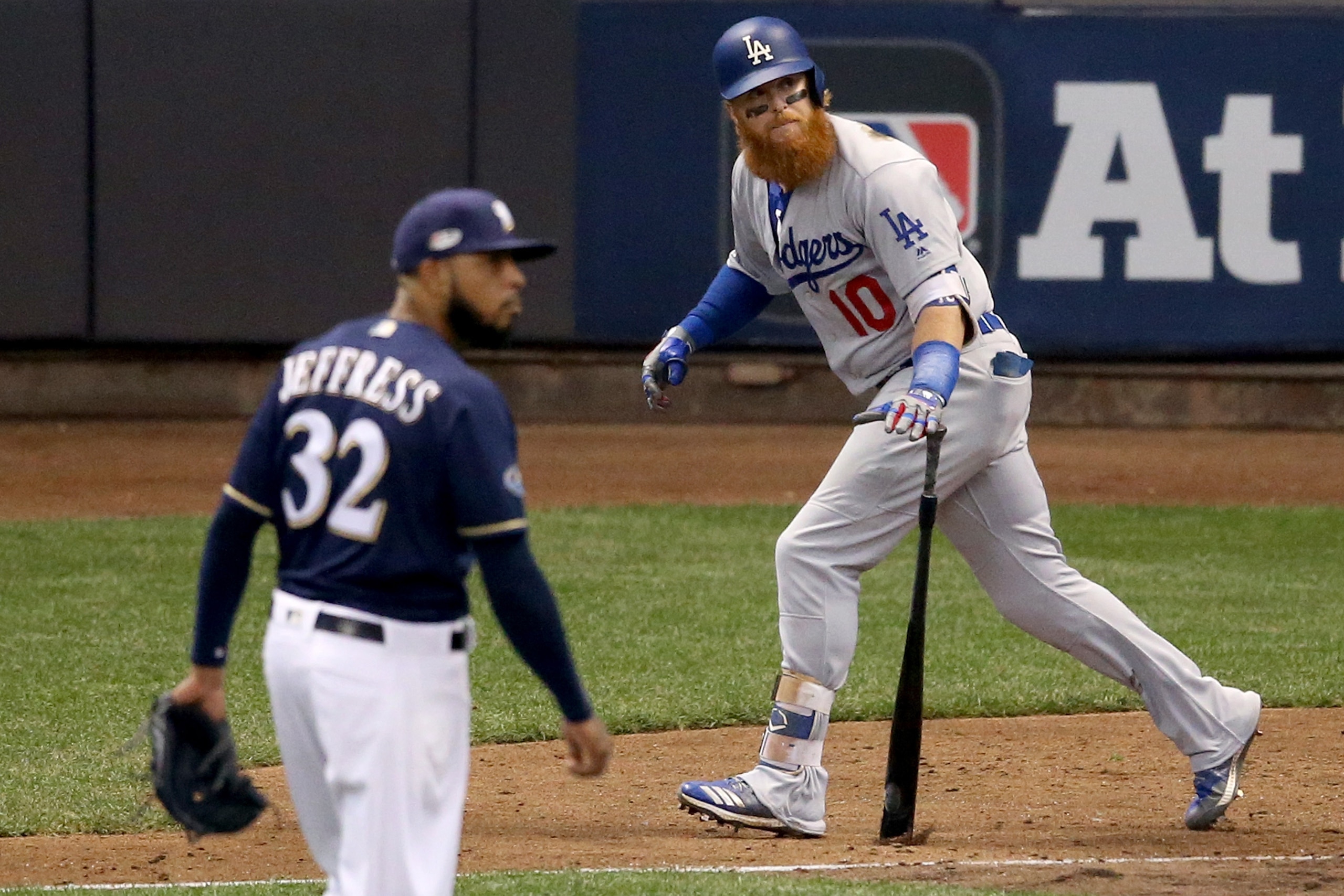 MILWAUKEE, WI - OCTOBER 13:  Justin Turner #10 of the Los Angeles Dodgers hits a two run home run against Jeremy Jeffress #32 of the Milwaukee Brewers during the eighth inning in Game Two of the National League Championship Series at Miller Park on Octobe