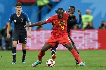 Belgium's forward Romelu Lukaku (C) is marked by France's midfielder Paul Pogba (R) during the Russia 2018 World Cup semi-final football match between France and Belgium at the Saint Petersburg Stadium in Saint Petersburg on July 10, 2018. (Photo by GABRI
