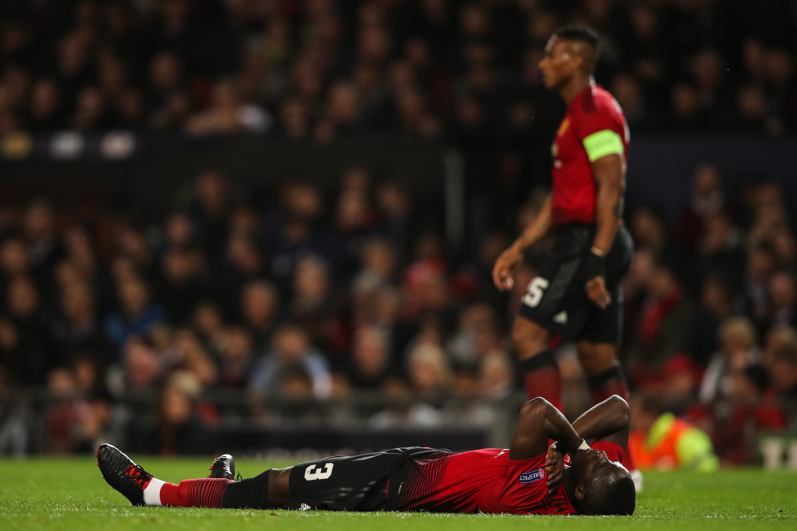 MANCHESTER, ENGLAND - OCTOBER 02: Eric Bailly of Manchester United reacts after an elbow from Rodrigo Moreno of Valencia during the Group H match of the UEFA Champions League between Manchester United and Valencia at Old Trafford on October 2, 2018 in Man