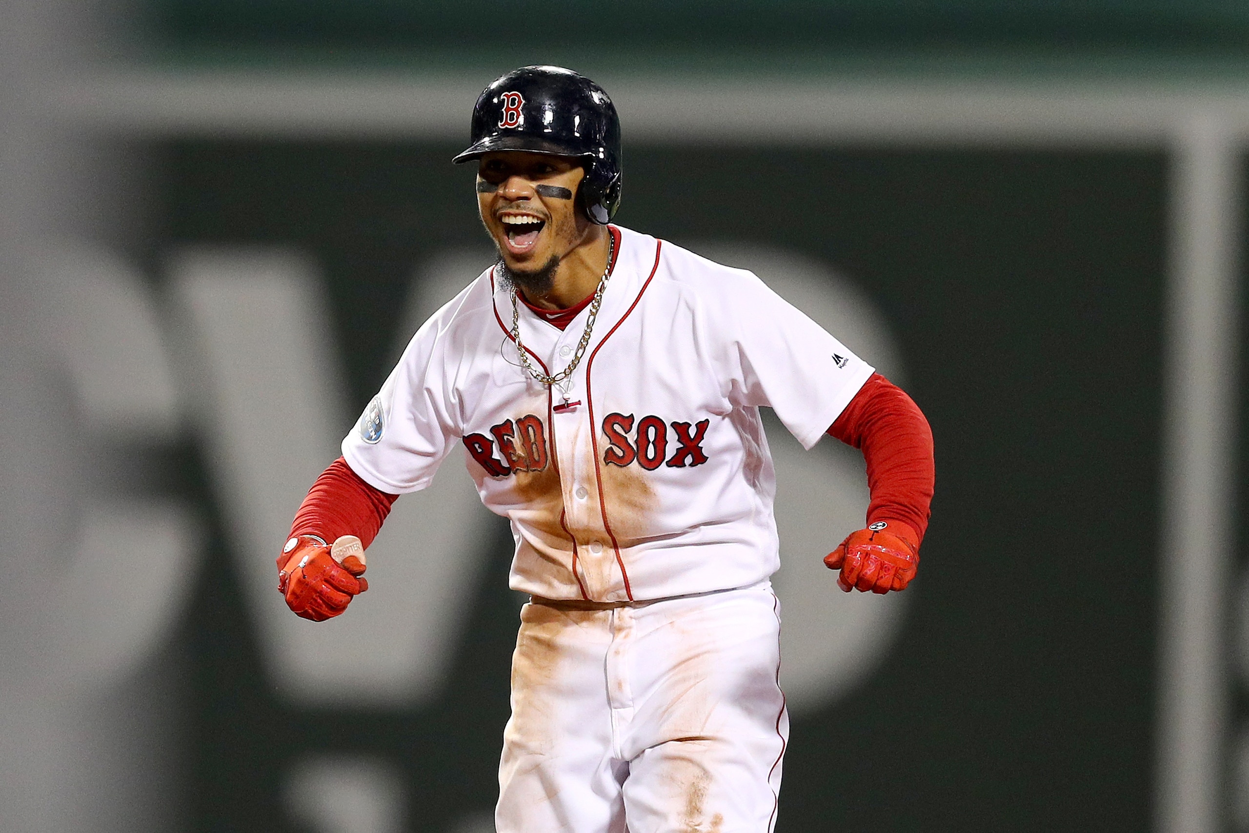 BOSTON, MA - OCTOBER 14:  Mookie Betts #50 of the Boston Red Sox celebrates his two-run double during the eighth inning against the Houston Astros in Game Two of the American League Championship Series at Fenway Park on October 14, 2018 in Boston, Massach