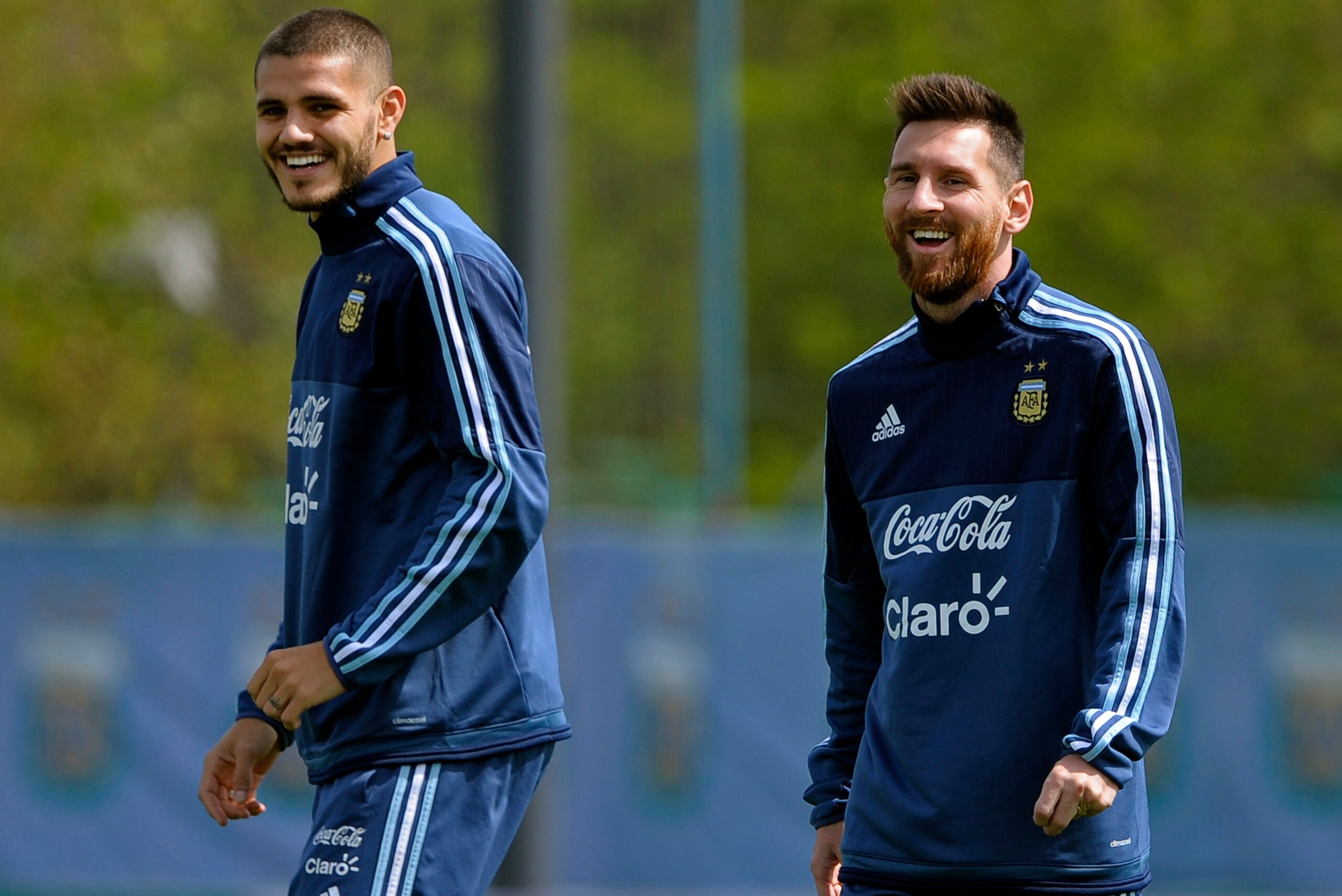 Argentina's forwards Lionel Messi (R) and Mauro Icardi laugh during a training session in Ezeiza, Buenos Aires on October 8, 2017 ahead of a 2018 FIFA World Cup South American qualifier football match against Ecuador to be held in Quito on October 10.  / 