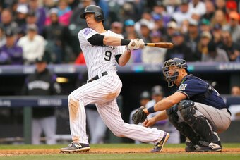 DENVER, CO - OCTOBER 07:  DJ LeMahieu #9 of the Colorado Rockies hits a double in the third inning of Game Three of the National League Division Series against the Milwaukee Brewers at Coors Field on October 7, 2018 in Denver, Colorado.  (Photo by Justin 