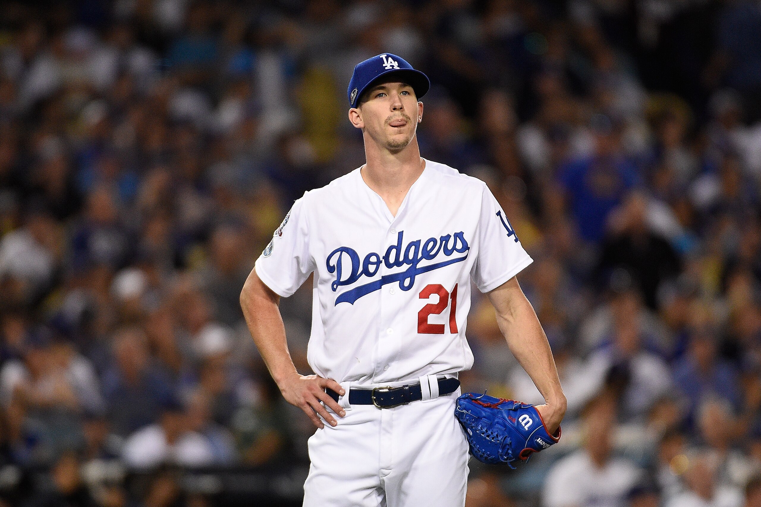 LOS ANGELES, CA - OCTOBER 15:  Pitcher Walker Buehler #21 of the Los Angeles Dodgers reacts after giving up a two-run home run during the seventh inning of Game Three of the National League Championship Series against the Milwaukee Brewers at Dodger Stadi