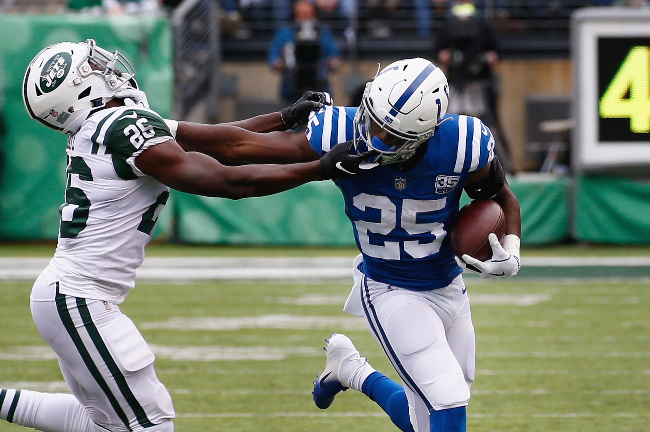 EAST RUTHERFORD, NJ - OCTOBER 14: Running back Marlon Mack #25 of the Indianapolis Colts runs the ball against free safety Marcus Maye #26 of the New York Jets during the third quarter at MetLife Stadium on October 14, 2018 in East Rutherford, New Jersey.