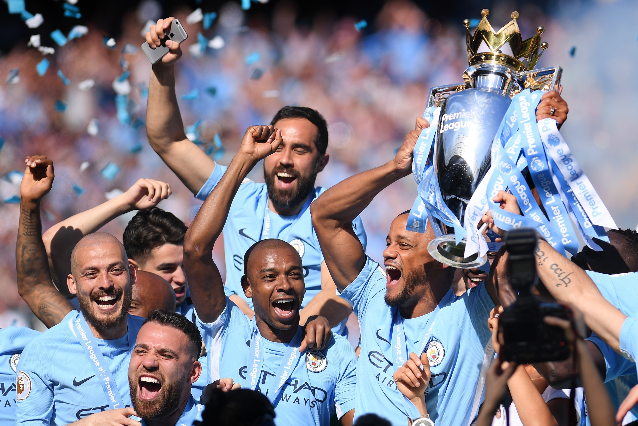 MANCHESTER, ENGLAND - MAY 06:  Vincent Kompany of Manchester City lifts the Premier League Trophy alongside David Silva, Nicolas Otamendi and Fernandinho as Manchester City celebrate winning the Premier League Title during the Premier League match between