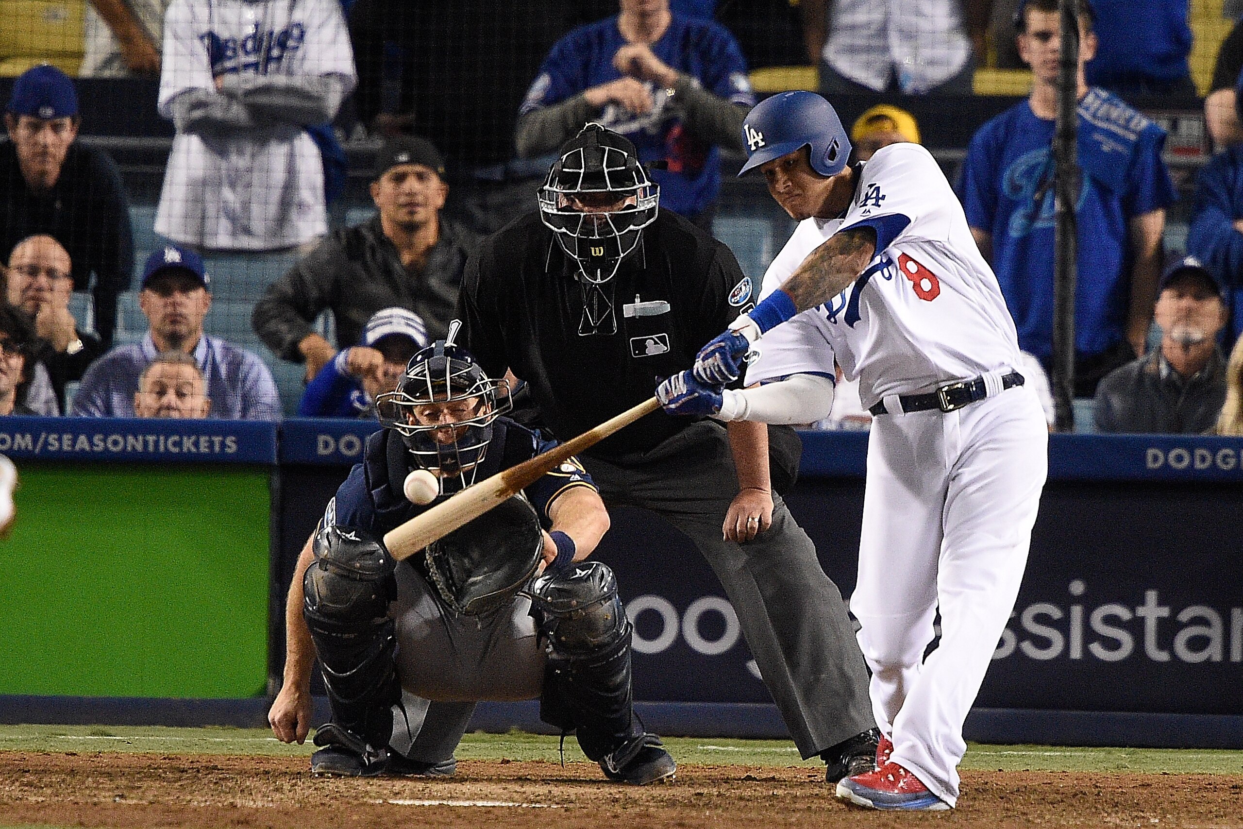 LOS ANGELES, CA - OCTOBER 16:  Manny Machado #8 of the Los Angeles Dodgers hits a single thirteenth inning against the Milwaukee Brewers in Game Four of the National League Championship Series at Dodger Stadium on October 16, 2018 in Los Angeles, Californ