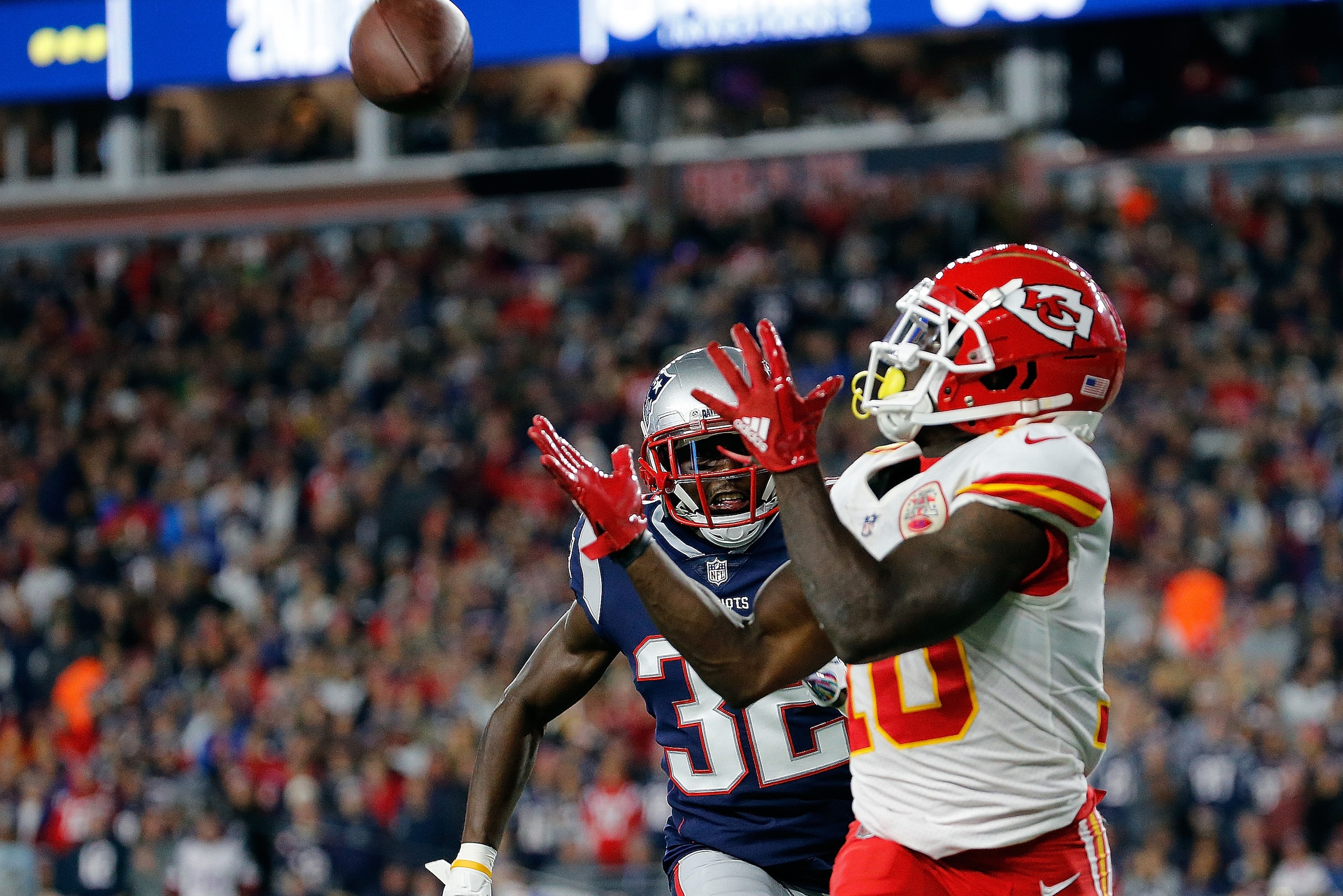 FOXBOROUGH, MA - OCTOBER 14: Tyreek Hill #10 of the Kansas City Chiefs catches a touchdown pass against the defense of Devin McCourty #32 of the New England Patriots in the third quarter at Gillette Stadium on October 14, 2018 in Foxborough, Massachusetts