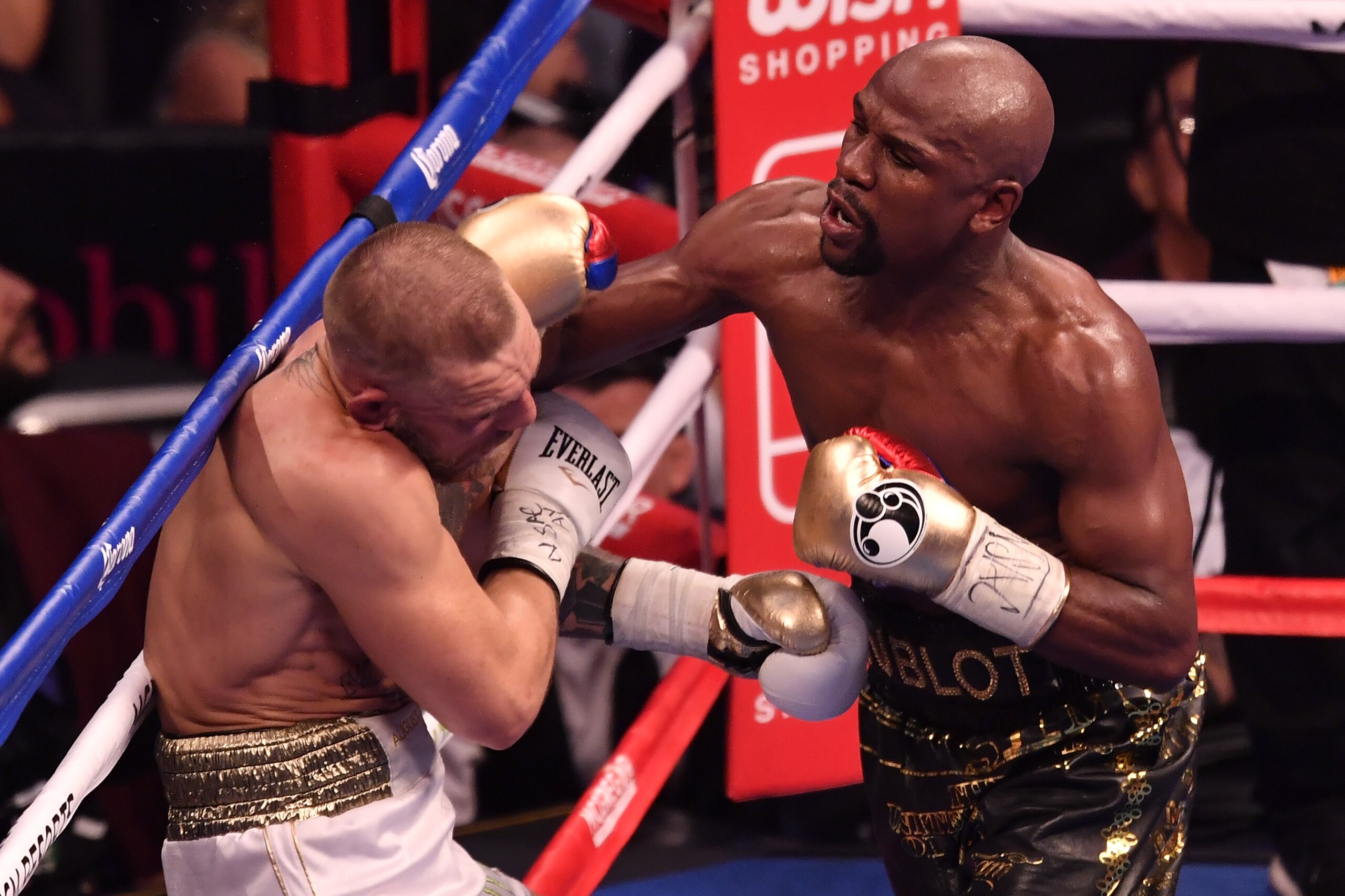 LAS VEGAS, NV - AUGUST 26: (R-L) Floyd Mayweather Jr. punches Conor McGregor in their super welterweight boxing match at T-Mobile Arena on August 26, 2017 in Las Vegas, Nevada. Mayweather won by 10th-round TKO. (Photo by Jeff Bottari/Zuffa LLC/Zuffa LLC LAS VEGAS, NV - AUGUST 26: (R-L) Floyd Mayweather Jr. punches Conor McGregor in their super welterweight boxing match at T-Mobile Arena on August 26, 2017 in Las Vegas, Nevada. Mayweather won by 10th-round TKO. (Photo by Jeff Bottari/Zuffa LLC/Zuffa LLC
