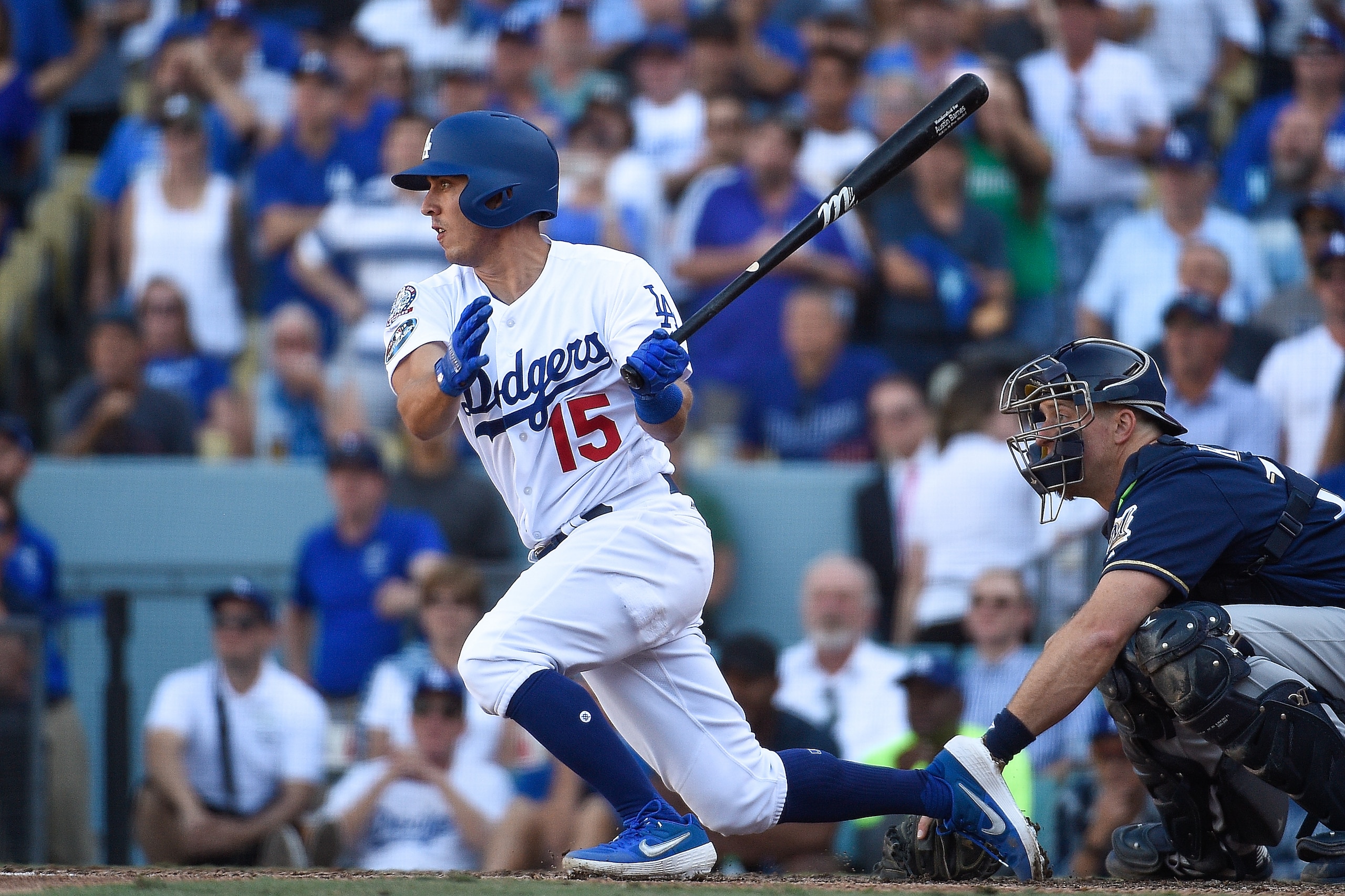 LOS ANGELES, CA - OCTOBER 17:  Austin Barnes #15 of the Los Angeles Dodgers hits a RBI single against the Milwaukee Brewers during the fifth inning in Game Five of the National League Championship Series at Dodger Stadium on October 17, 2018 in Los Angele