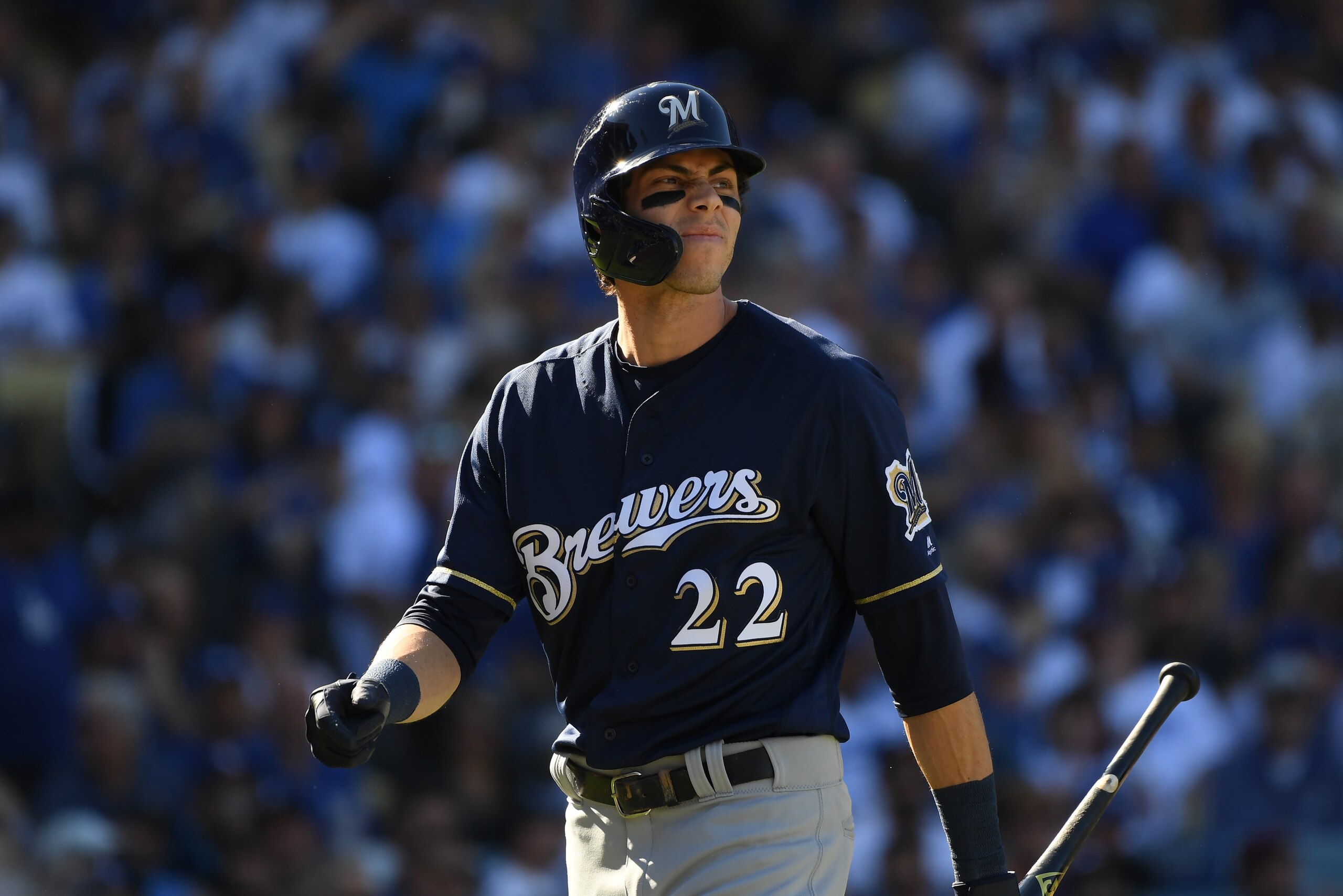 LOS ANGELES, CA - OCTOBER 17: Christian Yelich #22 of the Milwaukee Brewers reacts after striking out swinging during the third inning of Game Five of the National League Championship Series against the Los Angeles Dodgers at Dodger Stadium on October 17,