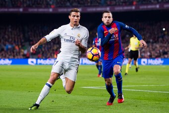BARCELONA, SPAIN - DECEMBER 03:  Cristiano Ronaldo (L) of Real Madrid CF competes for the ball with Jordi Alba (R) of FC Barcelona during the La Liga match between FC Barcelona and Real Madrid CF at Camp Nou stadium on December 3, 2016 in Barcelona, Spain