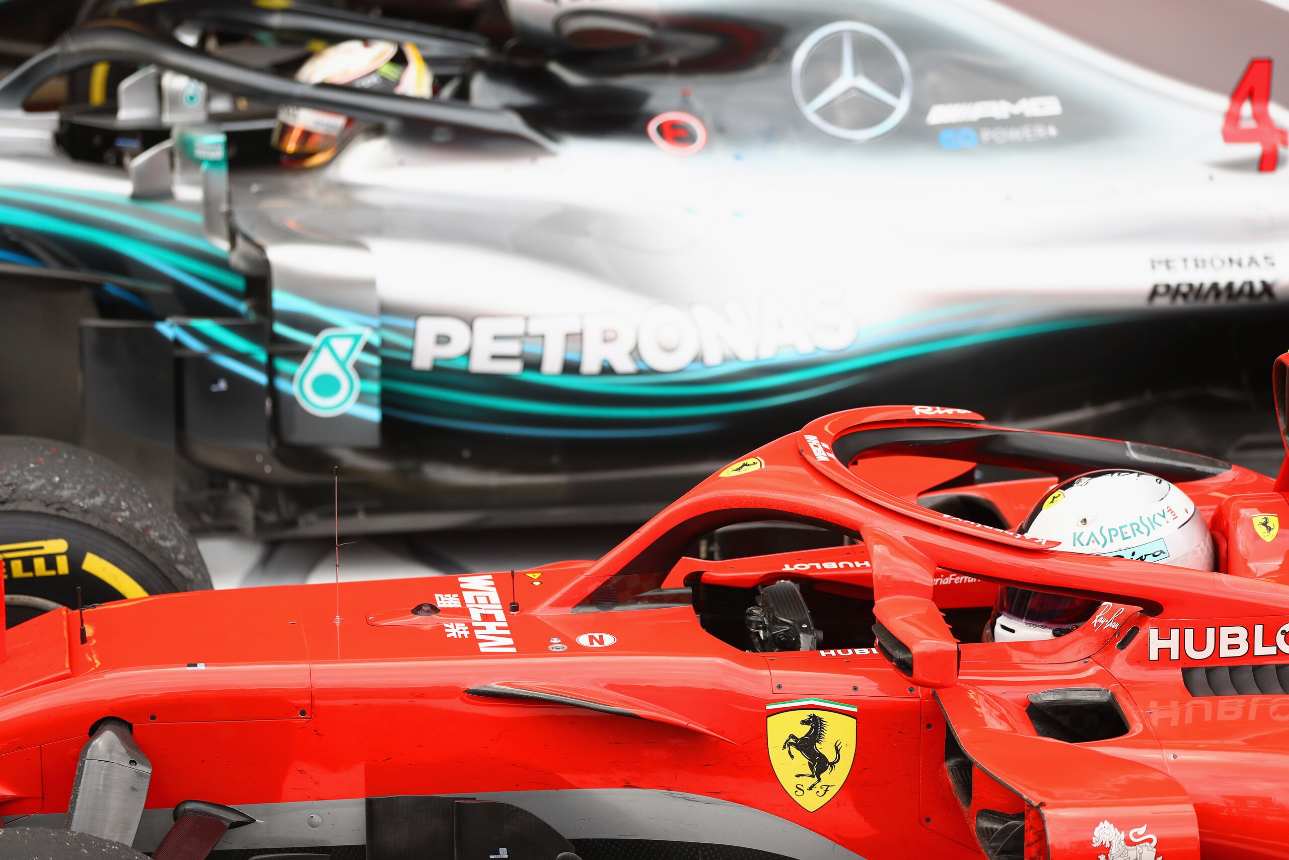 SOCHI, RUSSIA - SEPTEMBER 30: Third place finisher Sebastian Vettel of Germany and Ferrari stops in parc ferme next to race winner Lewis Hamilton of Great Britain and Mercedes GP during the Formula One Grand Prix of Russia at Sochi Autodrom on September 3