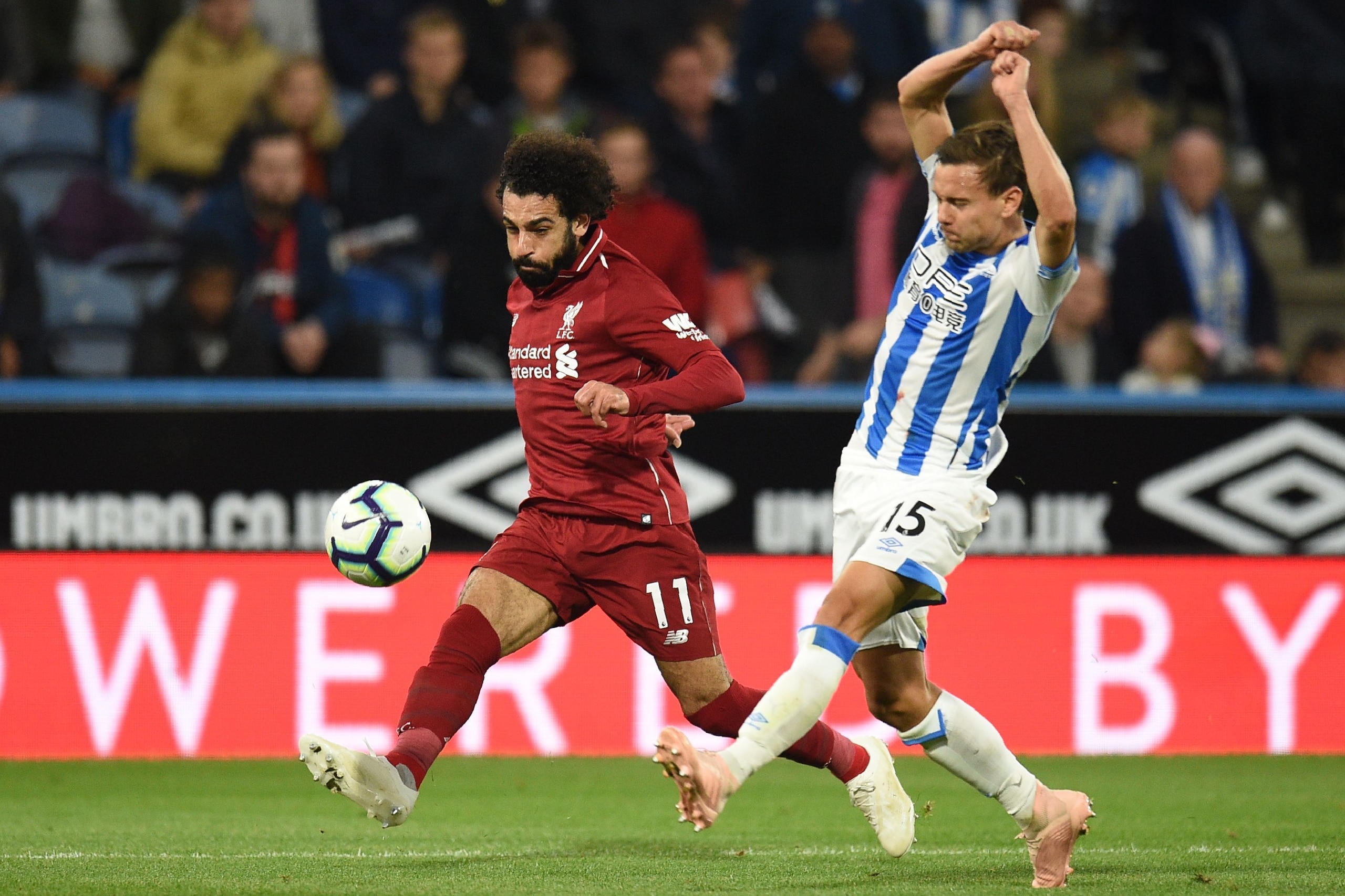Liverpool's Egyptian midfielder Mohamed Salah has an unsuccessful shot past Huddersfield Town's German defender Chris Lowe (R) during the English Premier League football match between Huddersfield Town and Liverpool at the John Smith's stadium in Huddersf