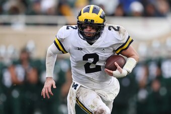 EAST LANSING, MI - OCTOBER 20:  Shea Patterson #2 of the Michigan Wolverines runs the ball in the second half while playing the Michigan State Spartans at Spartan Stadium on October 20, 2018 in East Lansing, Michigan. Michigan won the game 21-7. (Photo by