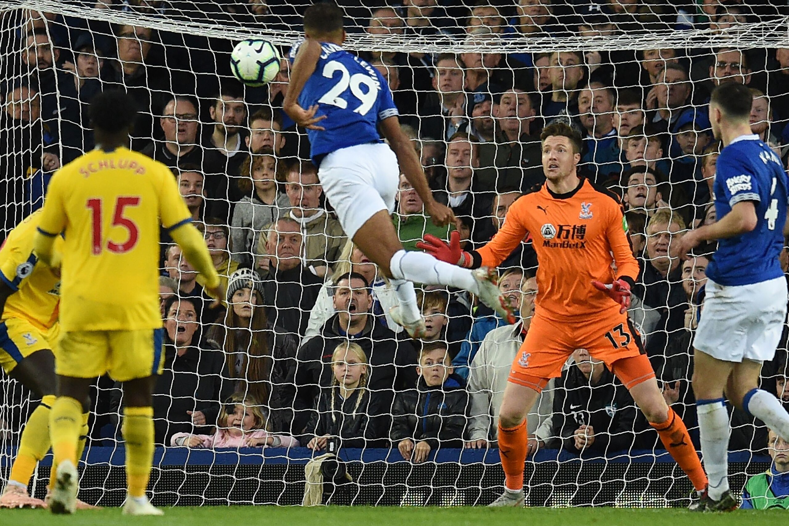 Everton's English striker Dominic Calvert-Lewin (C) jumps to head home the opening goal past Crystal Palace's Welsh goalkeeper Wayne Hennessey during the English Premier League football match between Everton and Crystal Palace at Goodison Park in Liverpoo