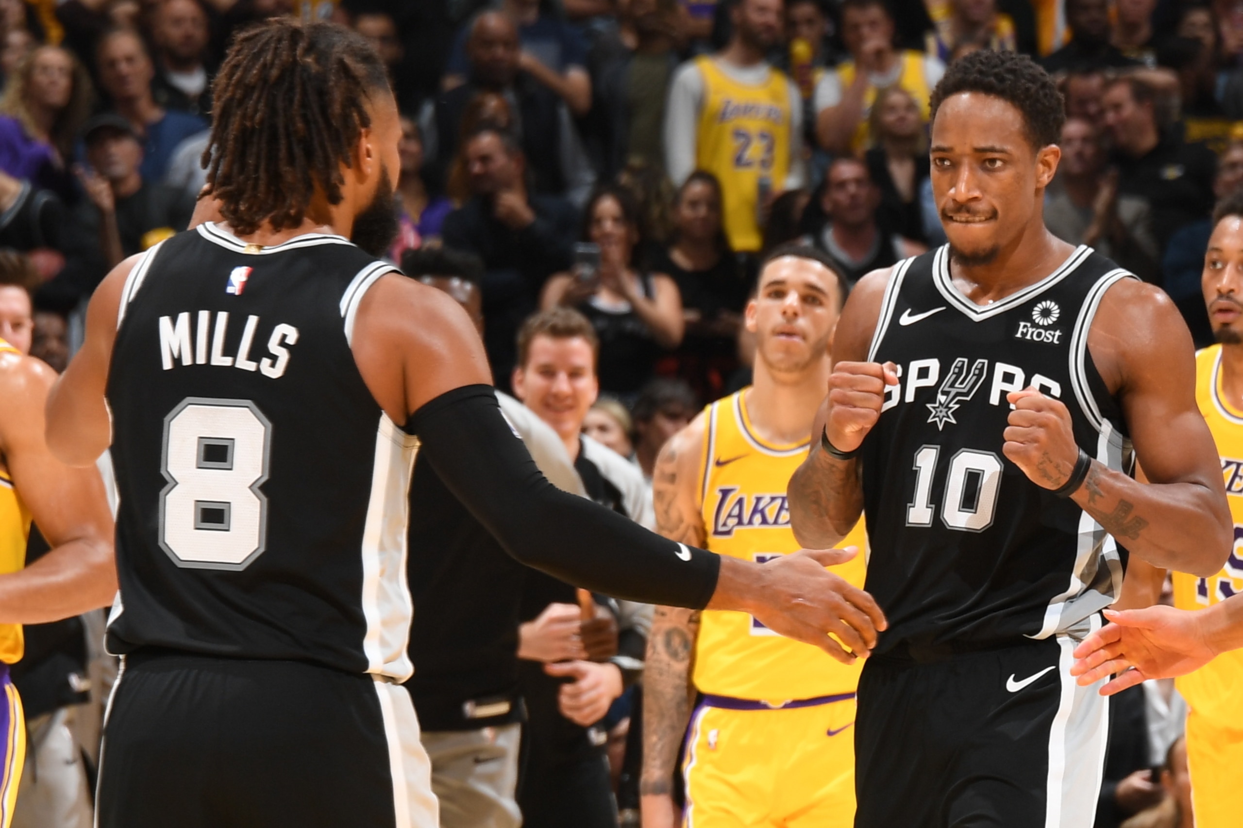 LOS ANGELES, CA - OCTOBER 22:  Patty Mills #8 DeMar DeRozan #10 and Bryn Forbes #11 of the San Antonio Spurs react during the gamge against the Los Angeles Lakers on October 22, 2018 at STAPLES Center in Los Angeles, California. NOTE TO USER: User express