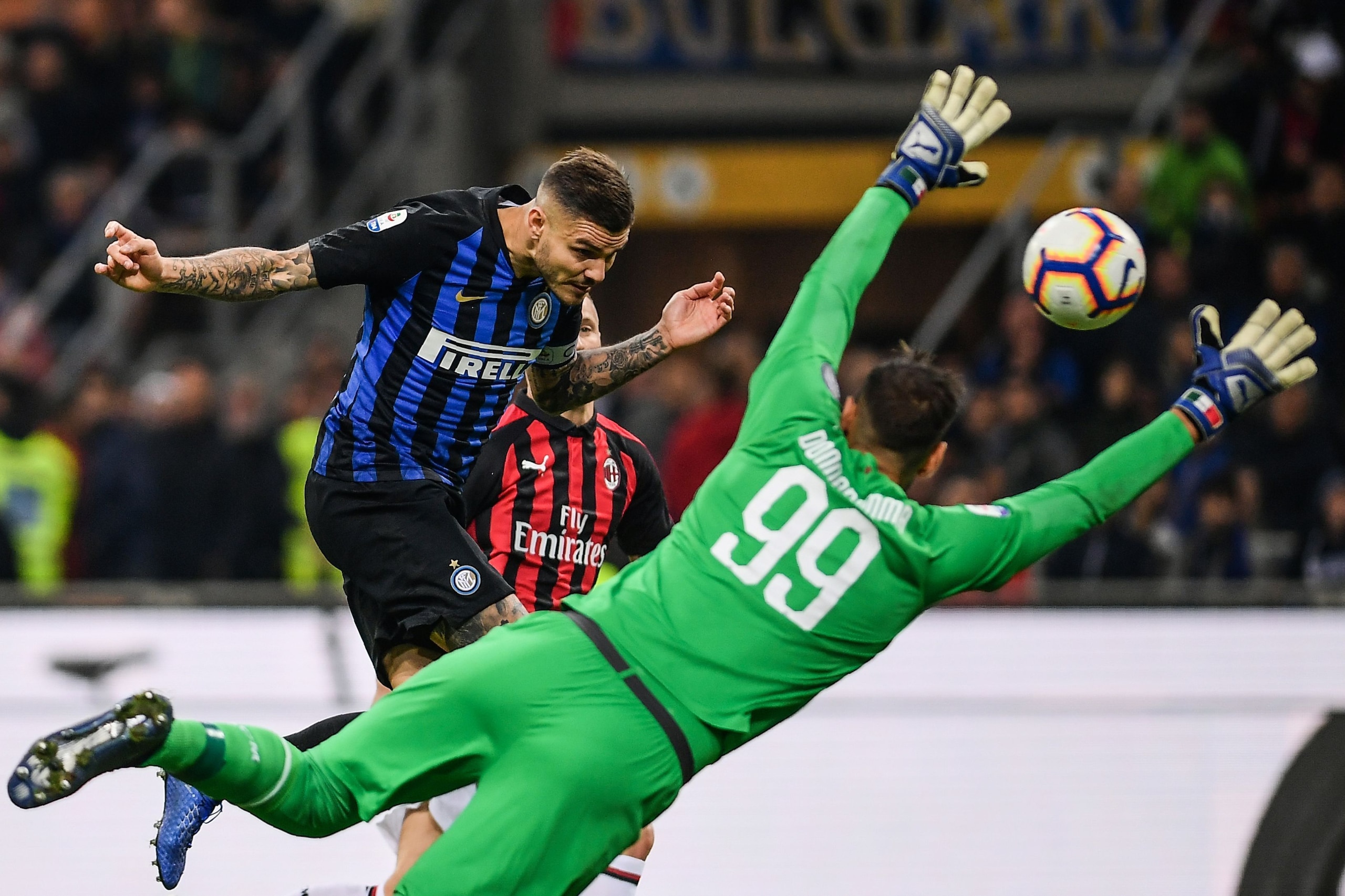 Inter Milan's Argentine forward Mauro Icardi (L) heads the ball to score the winning goal past AC Milan's Italian goalkeeper Gianluigi Donnarumma during the Italian Serie A football match Inter Milan vs AC Milan on October 21, 2018 at the San Siro stadium