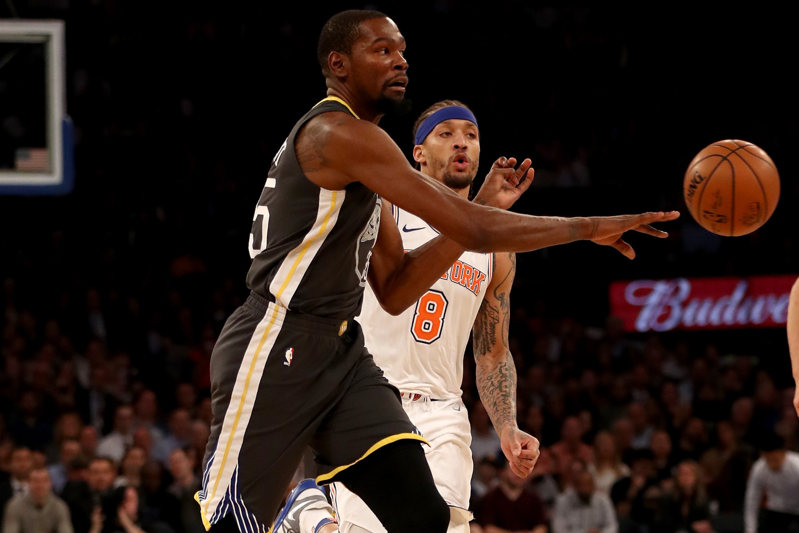 NEW YORK, NY - FEBRUARY 26:  Kevin Durant #35 of the Golden State Warriors passes the ball as Michael Beasley #8 of the New York Knicks defends at Madison Square Garden on February 26,2018 in New York City. NOTE TO USER: User expressly acknowledges and ag