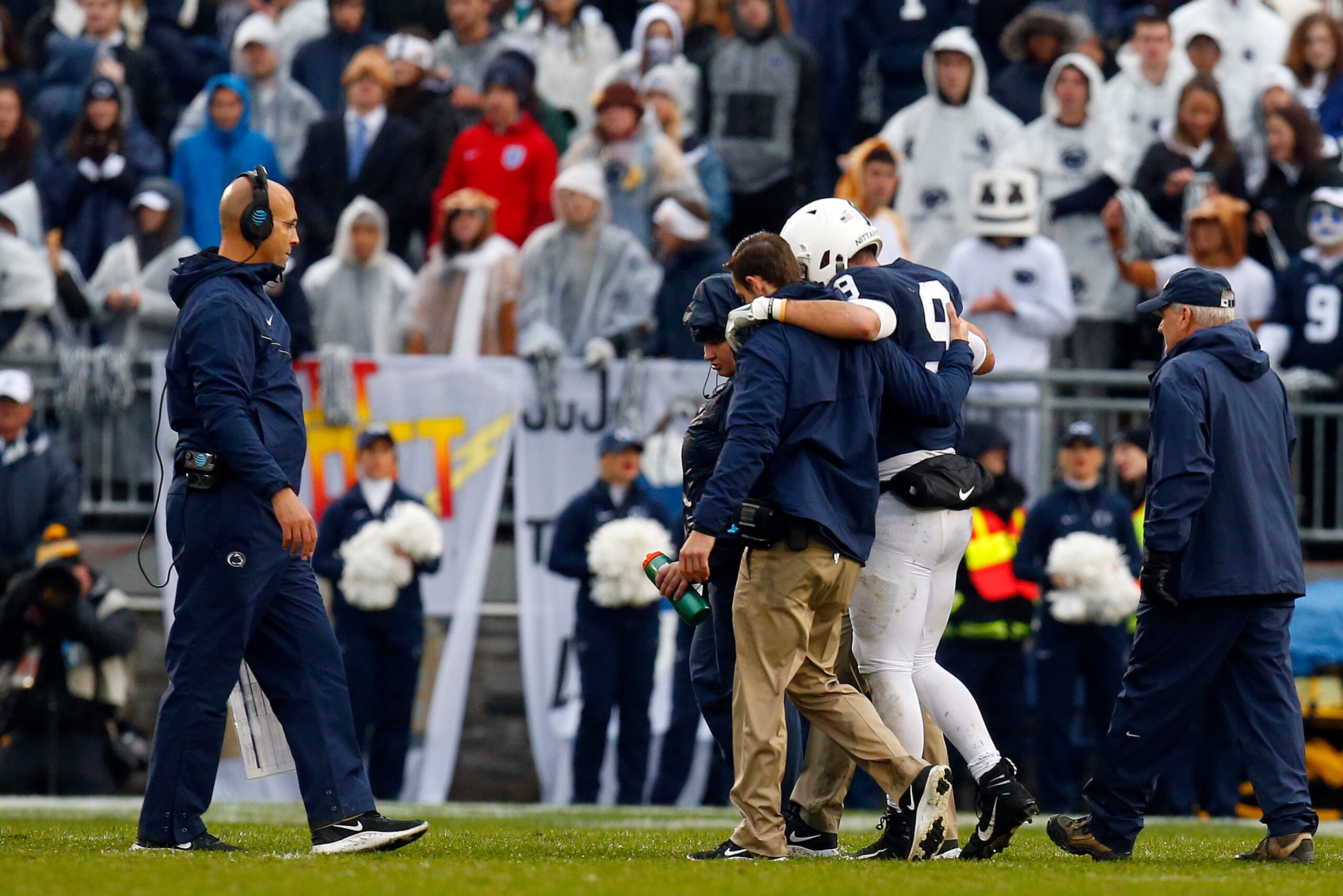 STATE COLLEGE, PA - OCTOBER 27:  Trace McSorley #9 of the Penn State Nittany Lions is helped off the field by medical staff as head coach James Franklin looks on against the Iowa Hawkeyes on October 27, 2018 at Beaver Stadium in State College, Pennsylvani