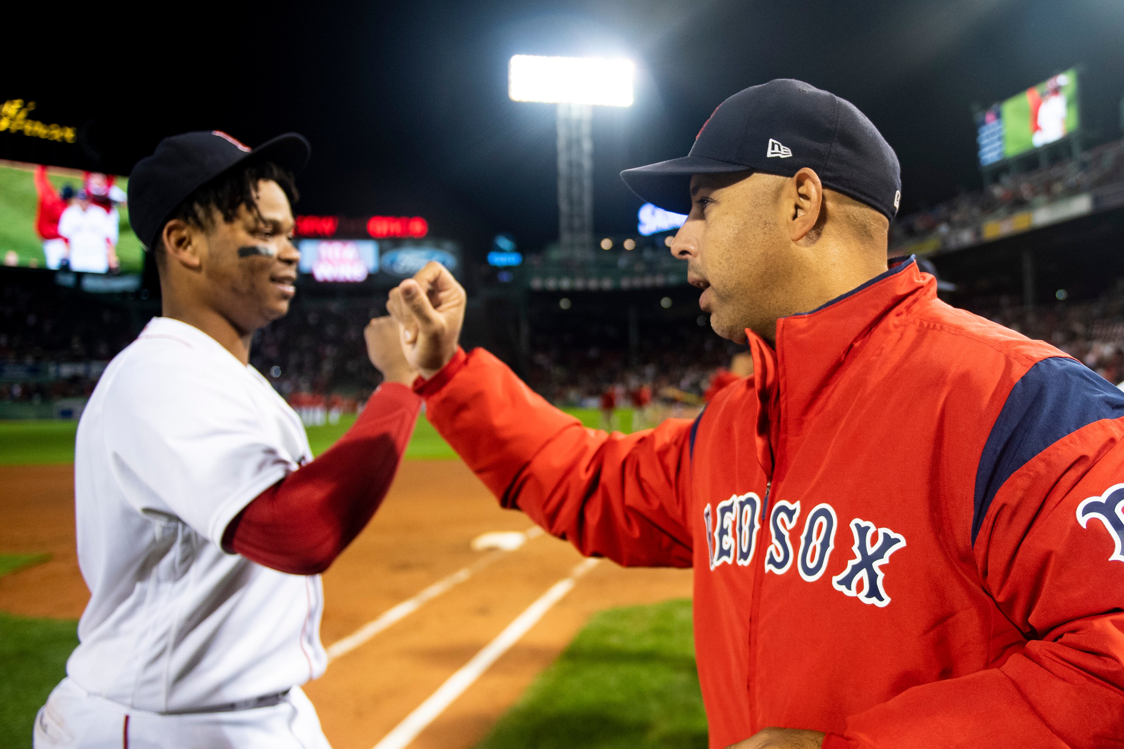 BOSTON, MA - SEPTEMBER 24: Manager Alex Cora of the Boston Red Sox high fives Rafael Devers #11 after a victory against the Baltimore Orioles to break the franchise record for most wins in a single season with 106 on September 24, 2018 at Fenway Park in B BOSTON, MA - SEPTEMBER 24: Manager Alex Cora of the Boston Red Sox high fives Rafael Devers #11 after a victory against the Baltimore Orioles to break the franchise record for most wins in a single season with 106 on September 24, 2018 at Fenway Park in B