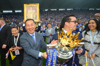 LEICESTER, ENGLAND - MAY 07:  Leceister City owner Vichai Srivaddhanaprabha (L) and son Aiyawatt Srivaddhanaprabha hold the Premier League Trophy after the Barclays Premier League match between Leicester City and Everton at The King Power Stadium on May 7